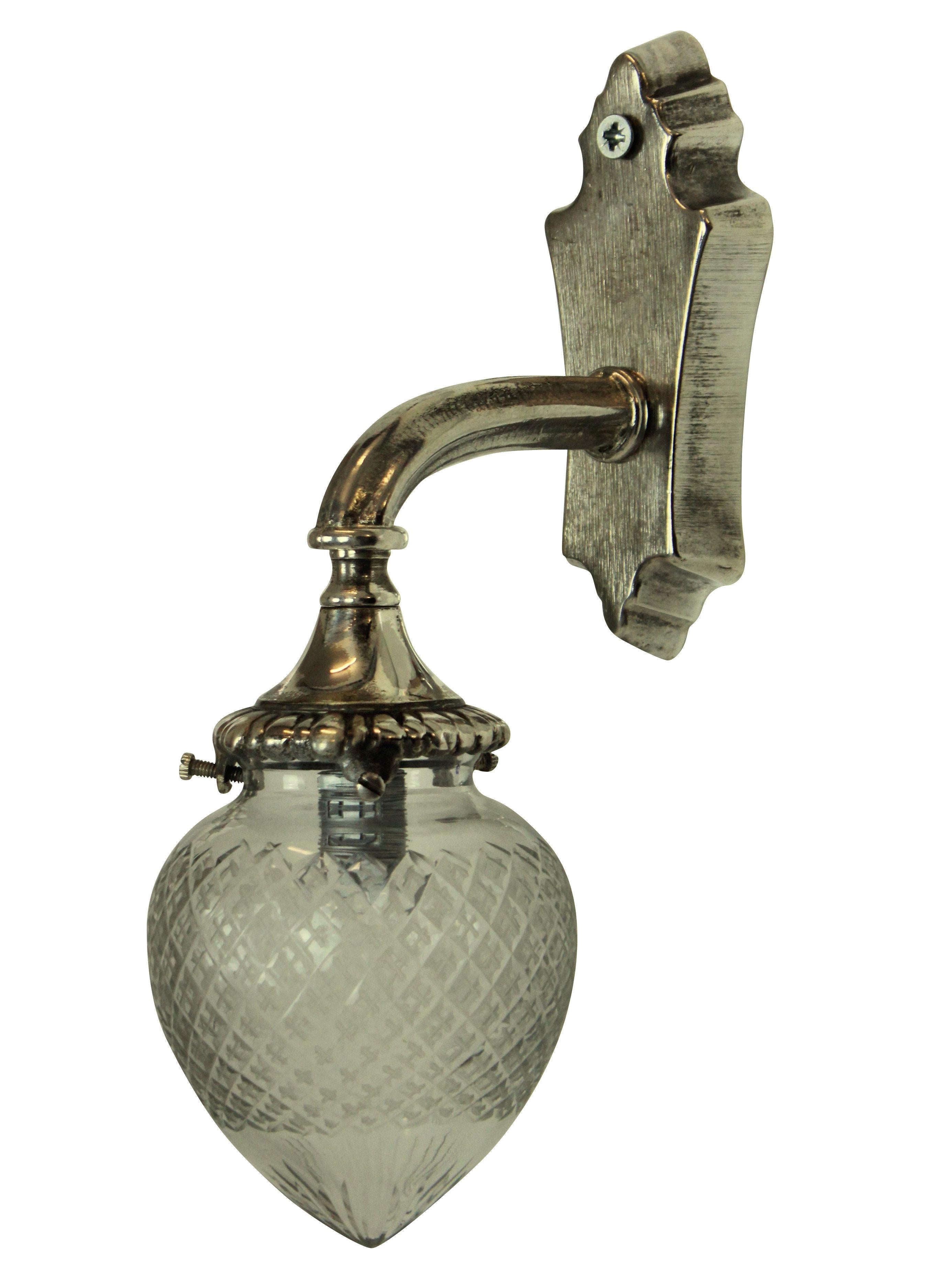 A set of four French silver wall bracket sconces with cut-glass globes.