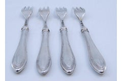 Set of four silver forks with three tines and crimped handles