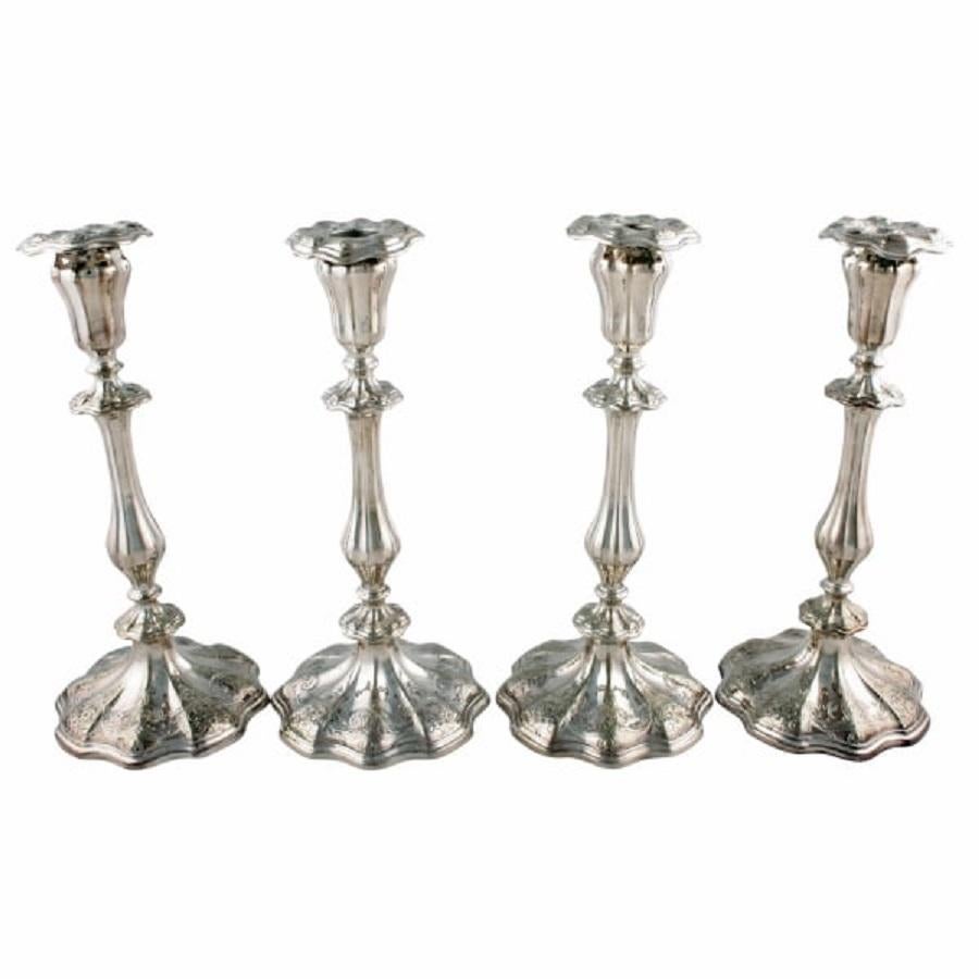 A set of four 19th century silver plated candlesticks.

The candlesticks have a shaped and engraved base with a fluted baluster stem that has engraved knop decoration.

The candle holder to the top is also fluted and the shaped sconce is