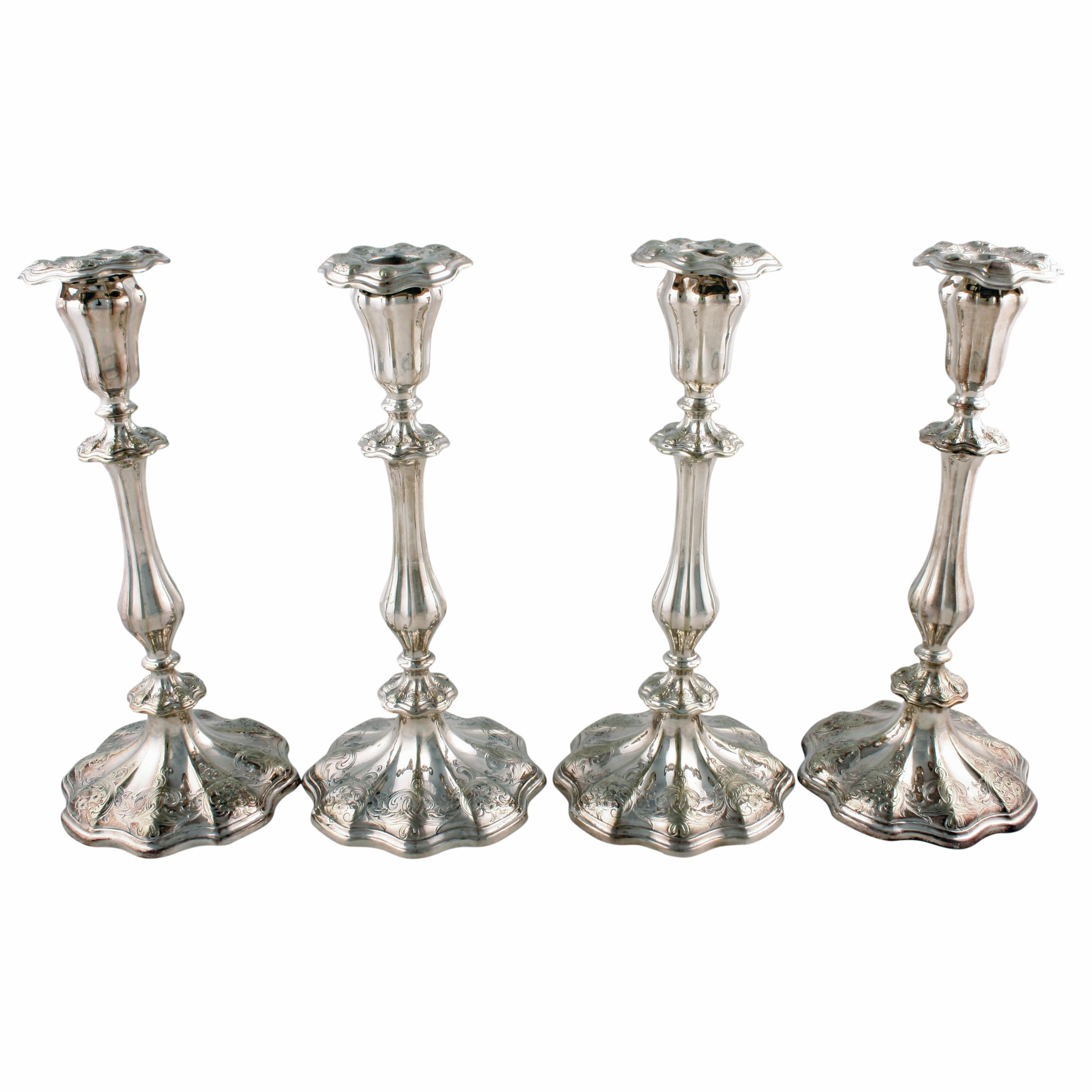 Four silver plated candlesticks
A set of four 19th century silver plated candlesticks.

The candlesticks have a shaped and engraved base with a fluted baluster stem that has engraved knop decoration.

The candleholder to the top is also fluted