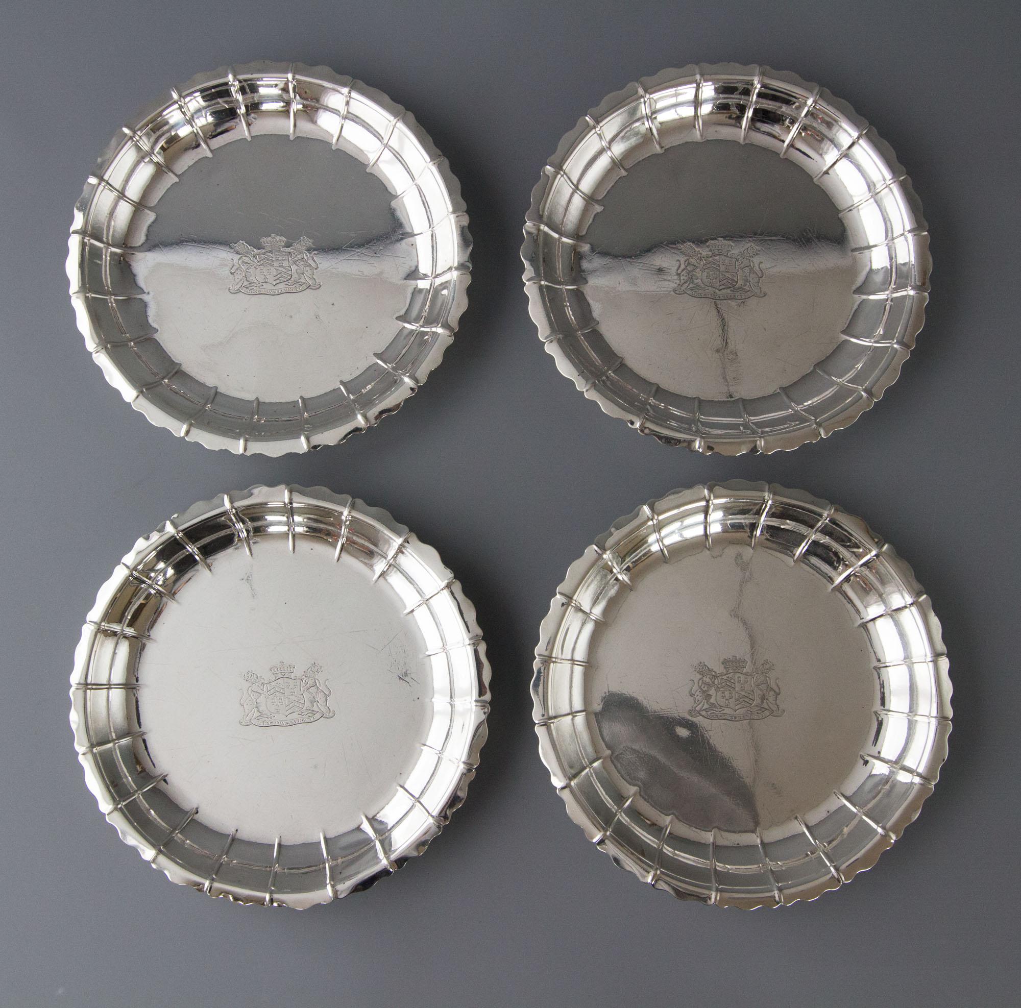 A very rare set of four silver strawberry or salad/serving dishes London 1835 by Robert Gerrard II. Each scalloped circular body with wavy rim, the center engraved with an armorial for Viscount Ashbrook. (See photo), with the motto 'Mens conscia