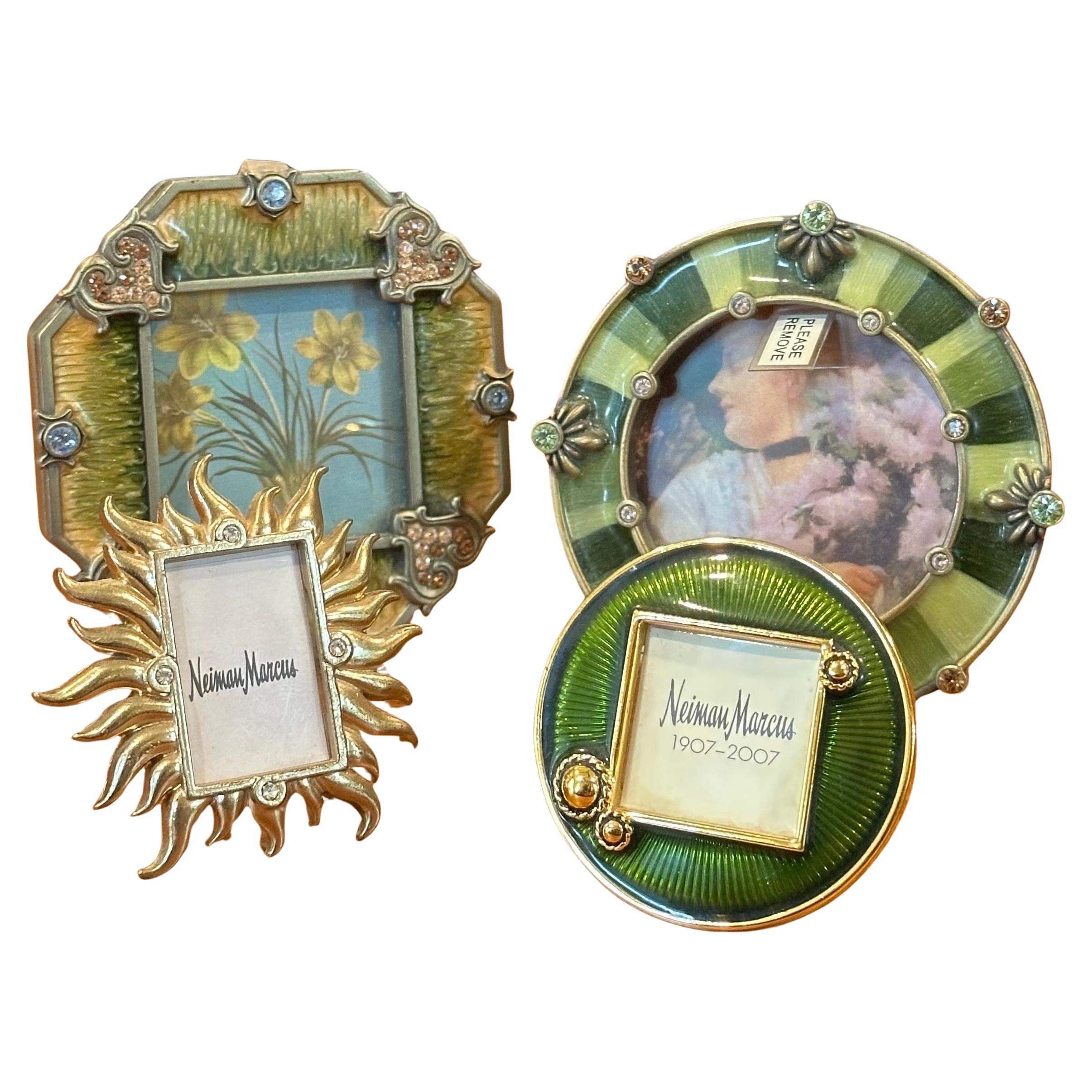 A gorgeous set of four small brass, enamel and Swarovski crystals picture frames by Jay Strongwater, circa 2000s. The set features four impressive jeweled frames measuring from 2