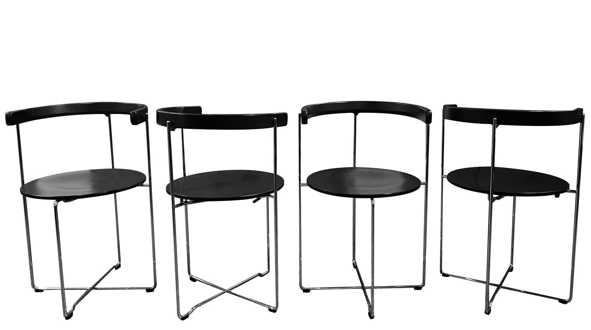 Set of four black stained wood and tubular steel iconic folding chairs designed in 1981 by Valdimar Hardarson for the Kusch and Co.

At the time it was named 