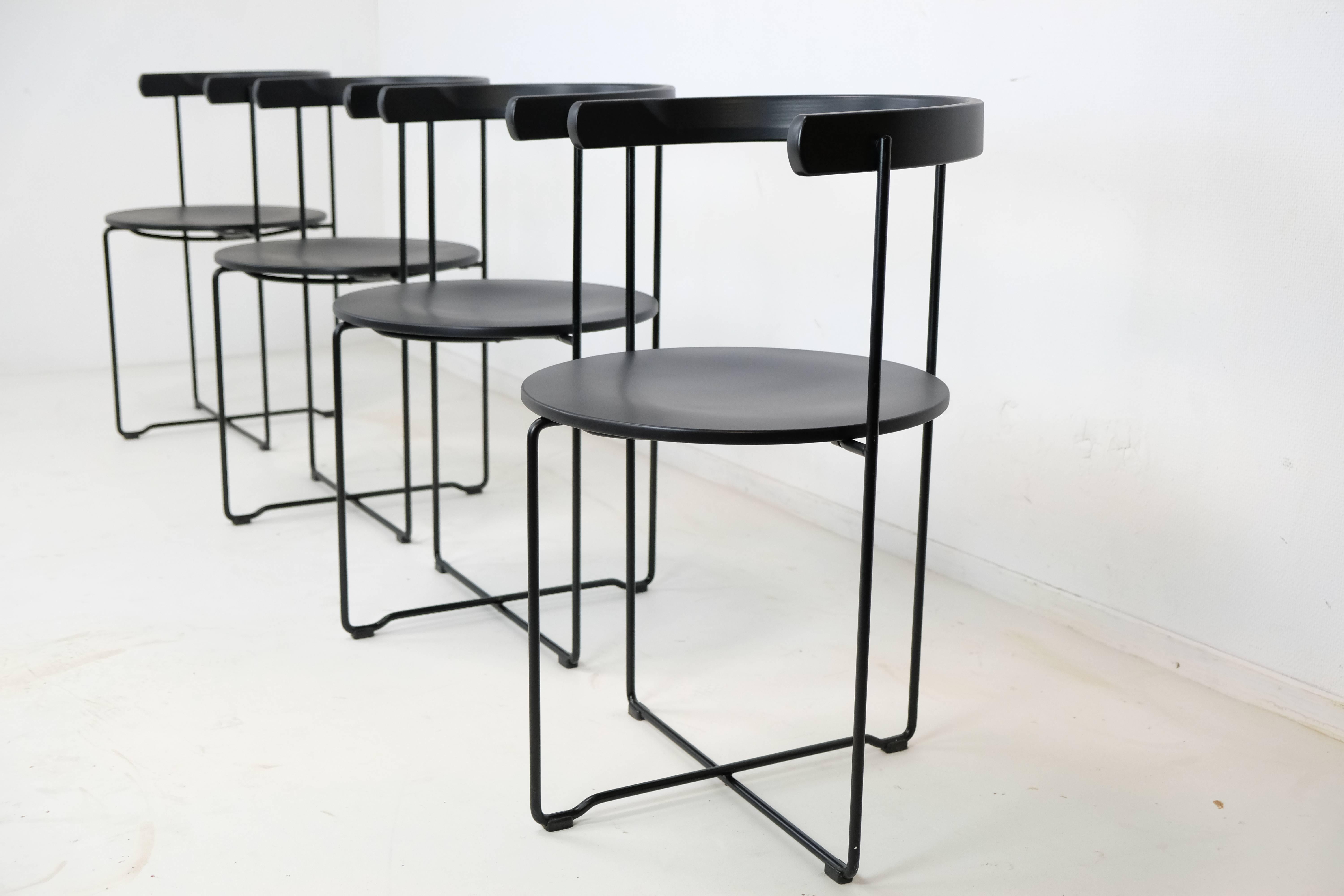 A set of four wood and tubular steel folding chairs designed in 1981 by Valdimar Hardarson for the Kusch and Co.
Ingeniously designed black lacquered wood and black enamel metal frame. The chairs store flat by open into perhaps the chicest folding