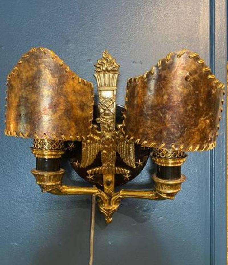 Set of Four Solid Brass Wall Sconces with Eagle & Stars Motif and Mica Shades. The sconces sport a patriotic motif with an eagle surrounded by stars. The mica shades give off a beautiful glow when turned on. Early 20th century, circa 1910. Wired for