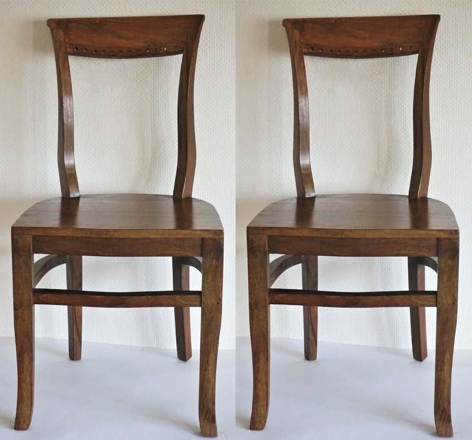 Four Art Deco solid oak dining chairs in elegant design with curved back providing comfortable support, late 1930s 
Measures: Height 35 in (89 cm)
Width 17.75 in (45 cm) 
Depth 17.75 in (45 cm)
Seat height 18 (45.5 cm).