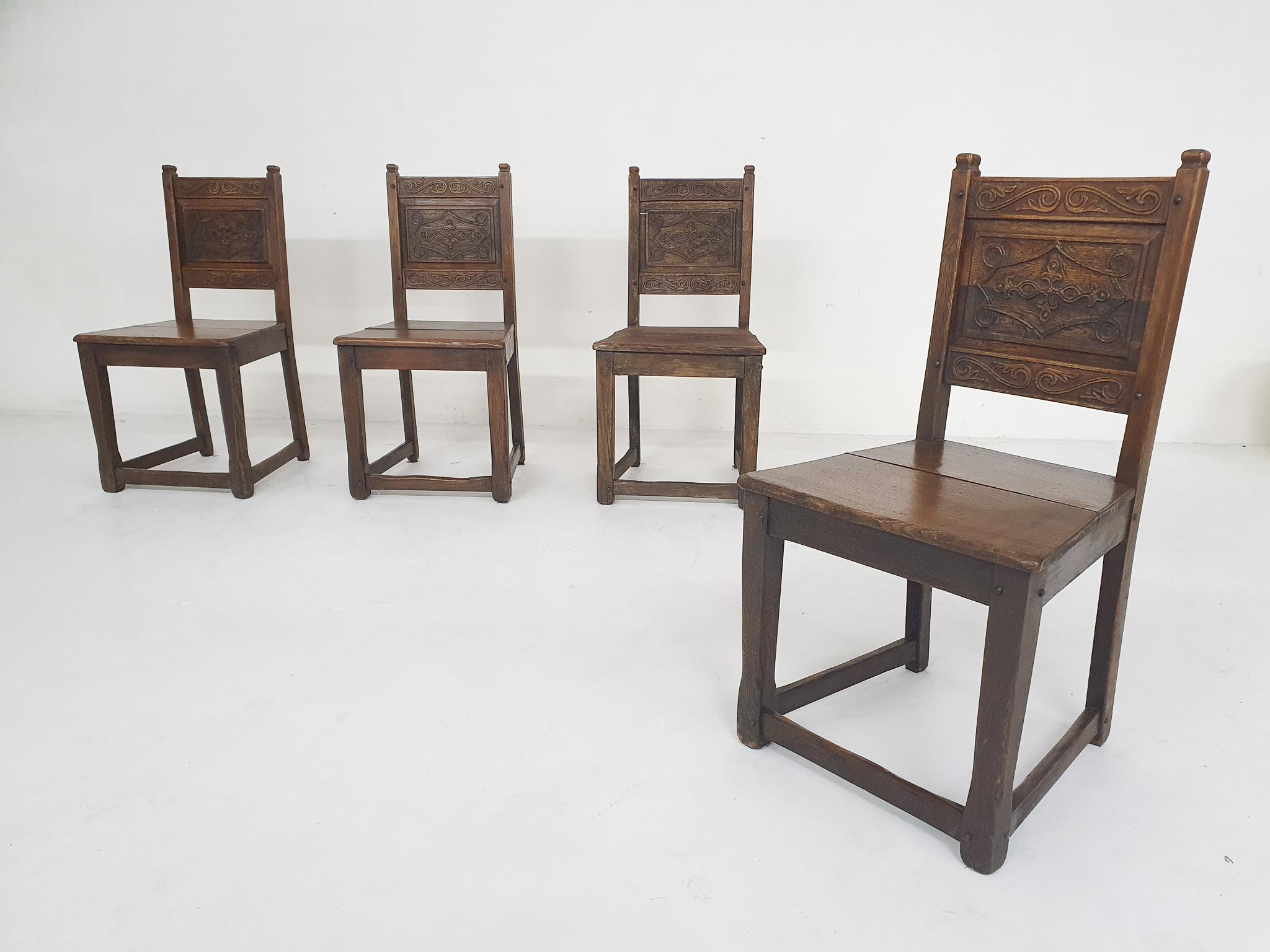 Set of four Spanish antique dining chairs, 1930's
Solid oak antique dining chairs, with hand carved back rests. The chairs have no screws only wooden joints, which makes the chairs a little wobly, but stable enough to sit on.