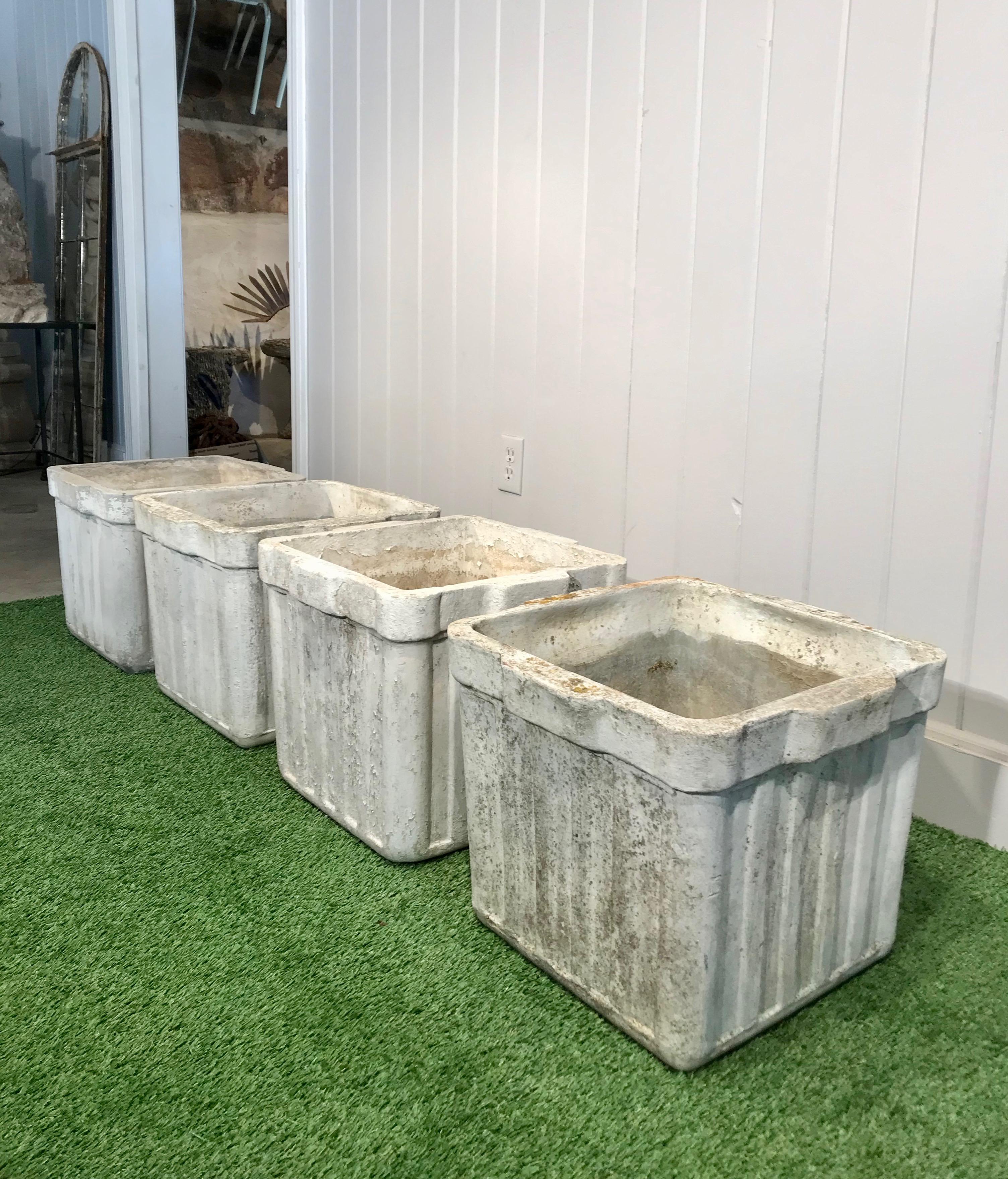 These ribbed planters with integral handles on two sides were designed by the iconic Willy Guhl and produced by Eternit of Switzerland in three sizes. These are the medium-sized ones. In very good structural condition, they feature a