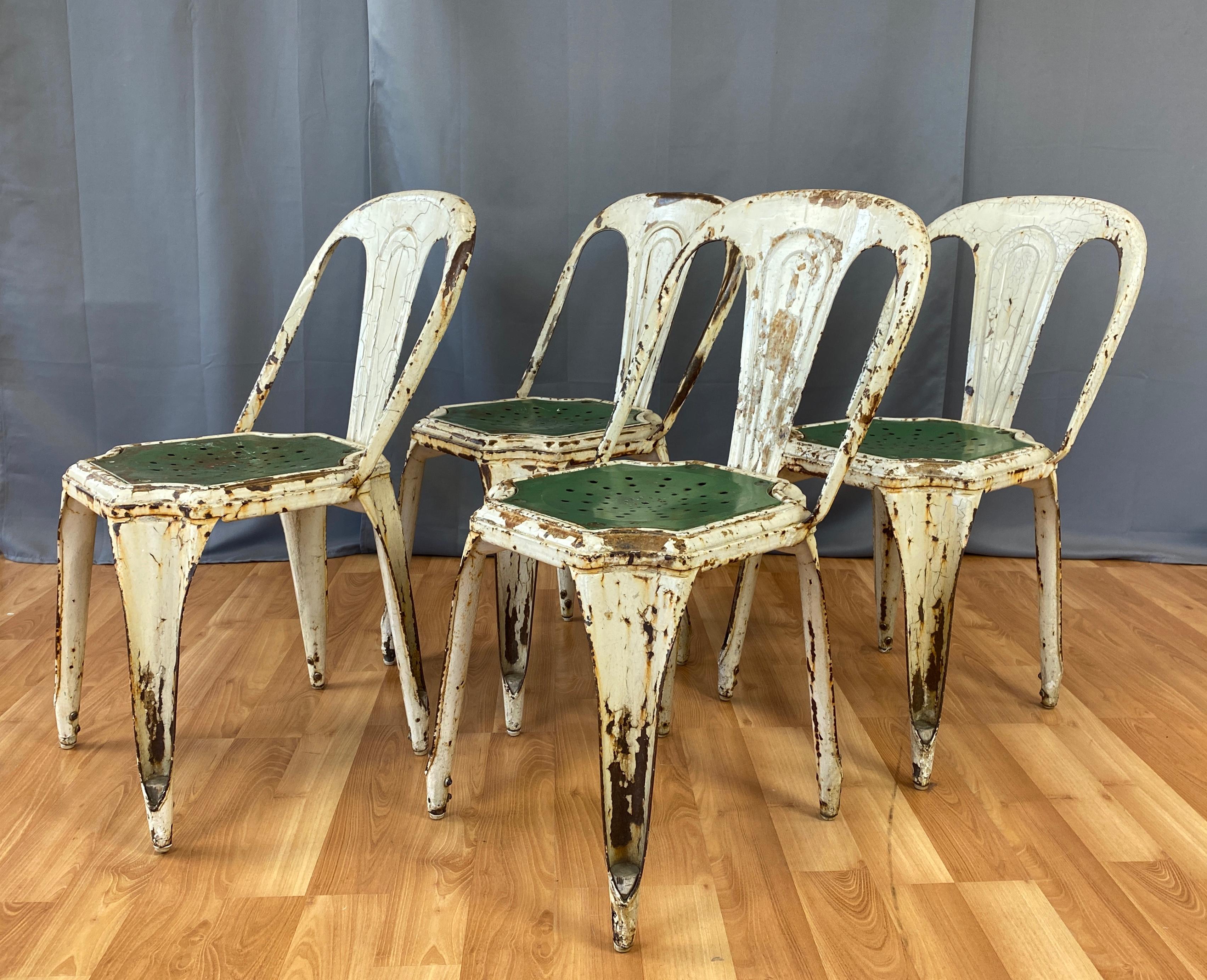 Set of four stackable industrial bistro chairs by Fibrocit of Belgium.
Produced in the 1950s, all metal in an off-white with green seats.
They have a handsome amount of age appropriate patina earned from years of outdoor cafe service, gives them