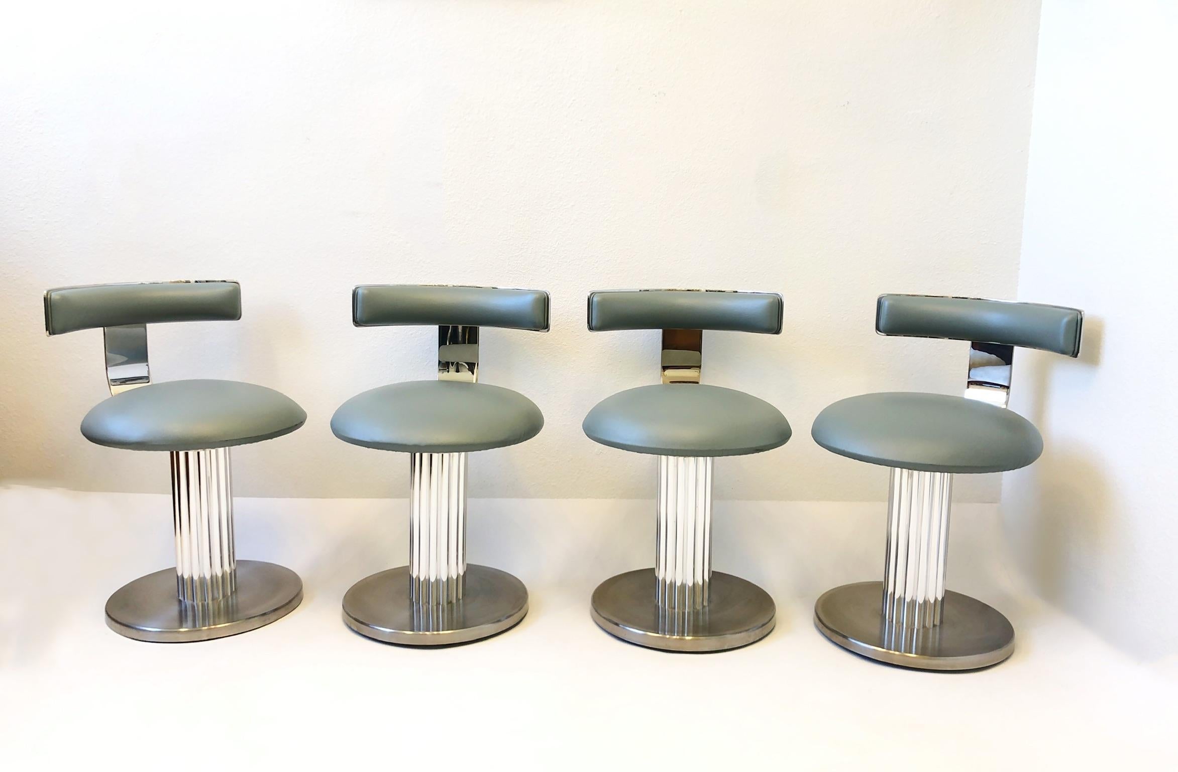 1980’s Swivel chairs or stools by Design for Leisure.
 Constructed of polish and brush stainless steel with original vinyl. 
Great for a sunken bar. Out of a Steve Chase designed estate. 
In great original condition, minor wear consistent with