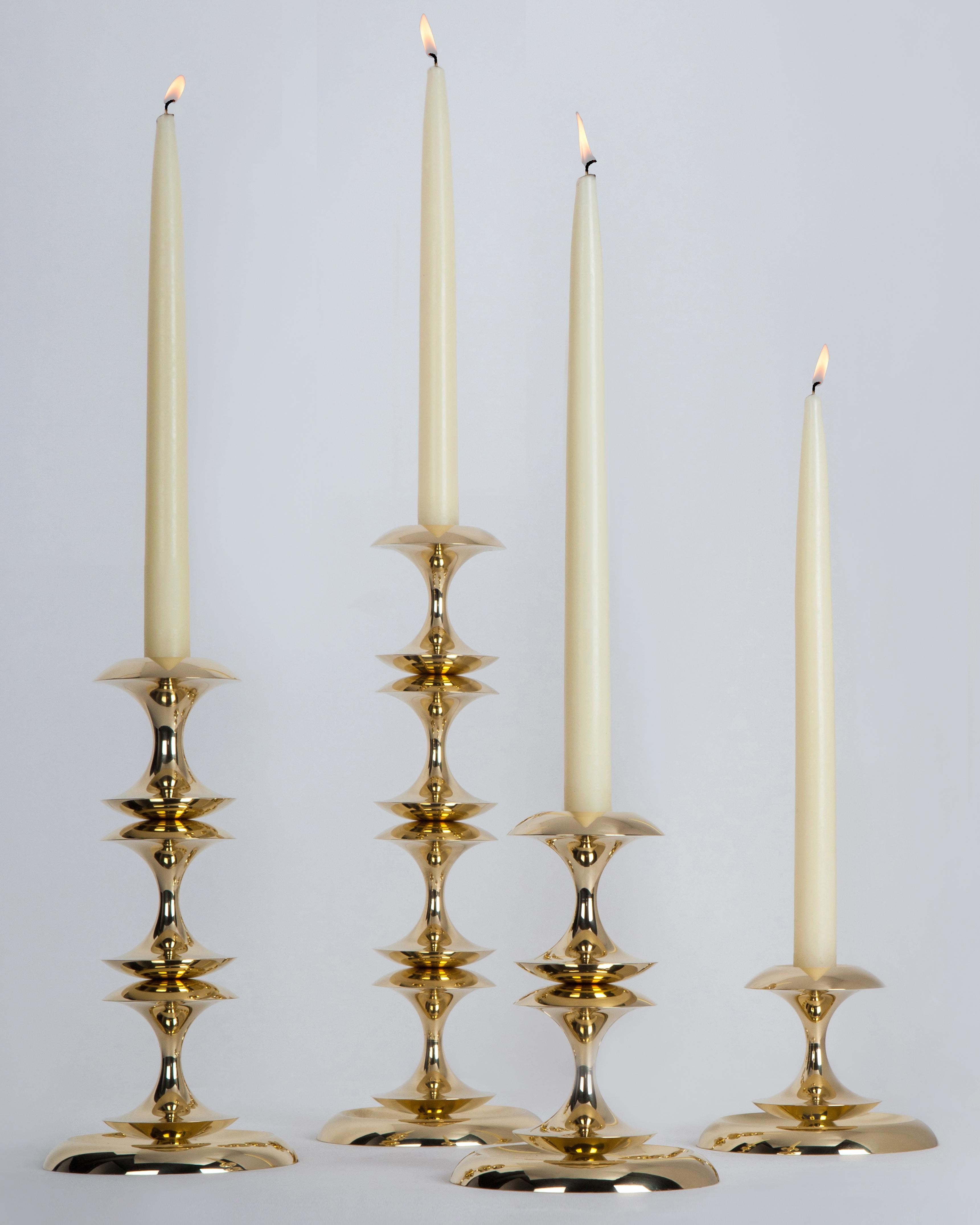 The profiles of the Stayman candlesticks are a play on the question of what is figure and what is ground, like Classic vase-or-face silhouettes. They are cut from round solid brass in four sizes; stack them up tall, use them in groups as a