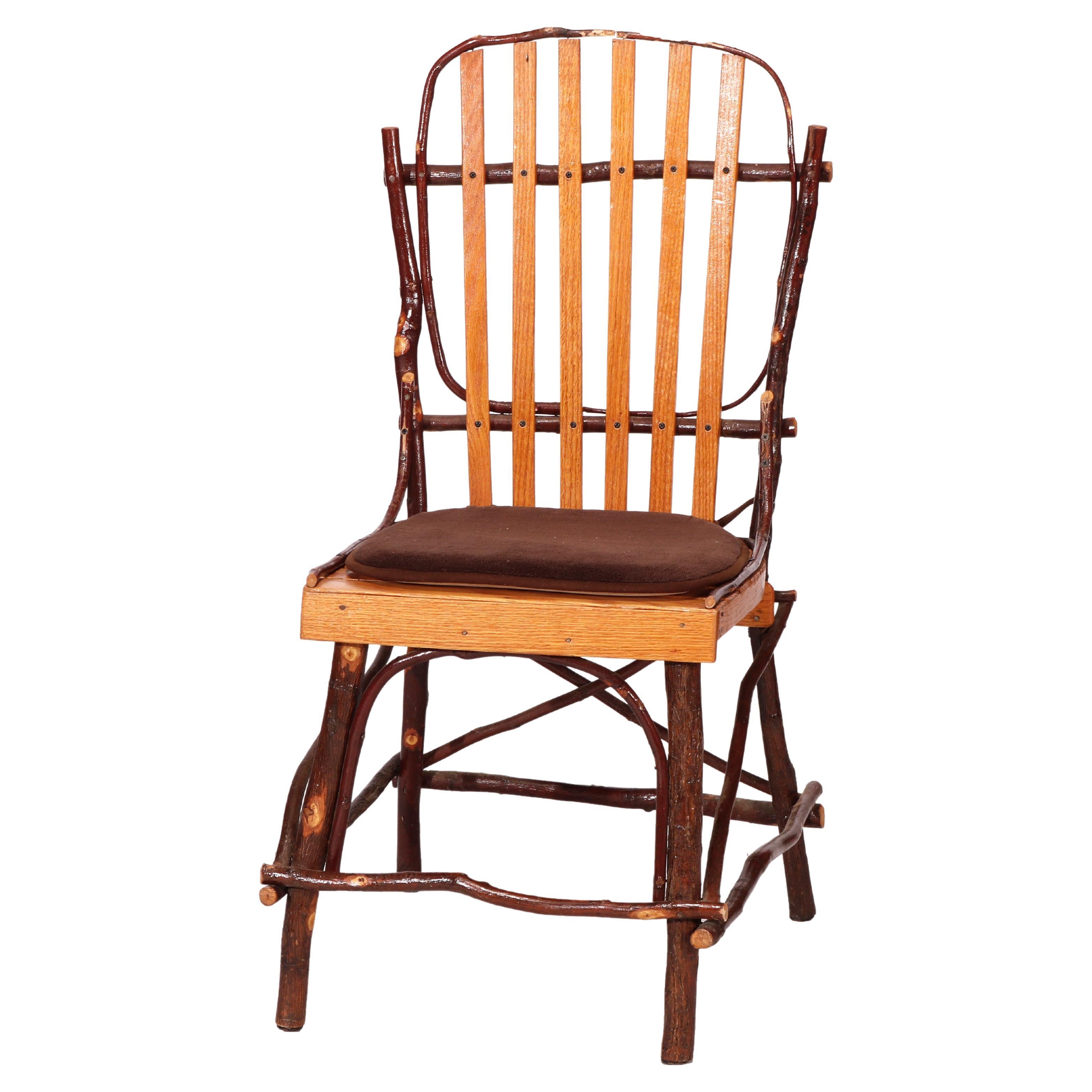 A set of four Old Hickory style dining side chairs offer stick form branch and slat construction, 20th century

Measures - 36''H x 18''W x 21.5''D.

Catalogue Note: Ask about DISCOUNTED DELIVERY RATES available to most regions within 1,500 miles of