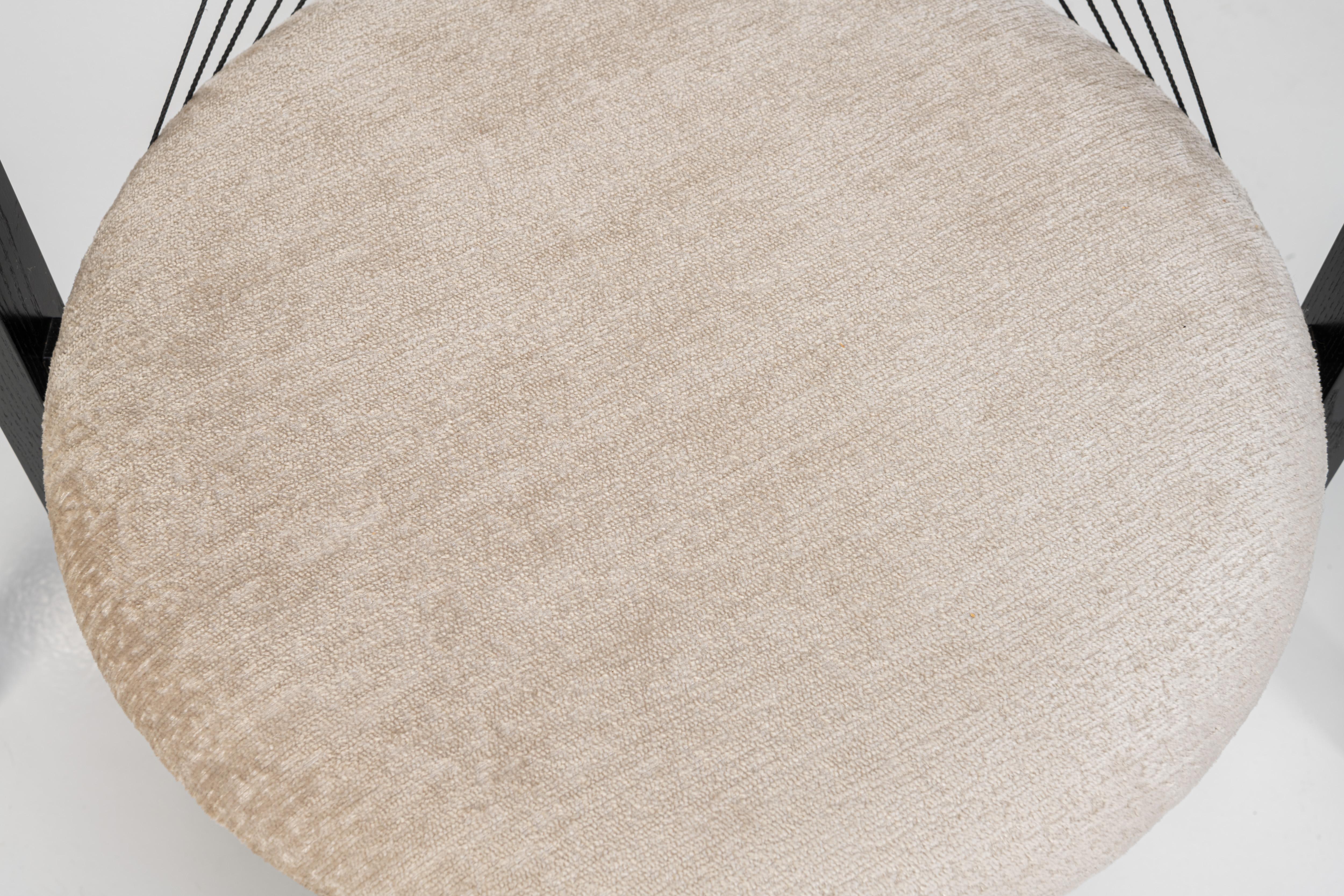 Set of four 'String' dining chairs designed by Niels Jørgen Haugesen for Tranekaer Furniture, Denmark 1990s. The chairs have a wooden frame and are reupholstered with a cream beige fabric. Marked by the producer.

Dimensions:
W: 56 cm
D: 54 cm
H: