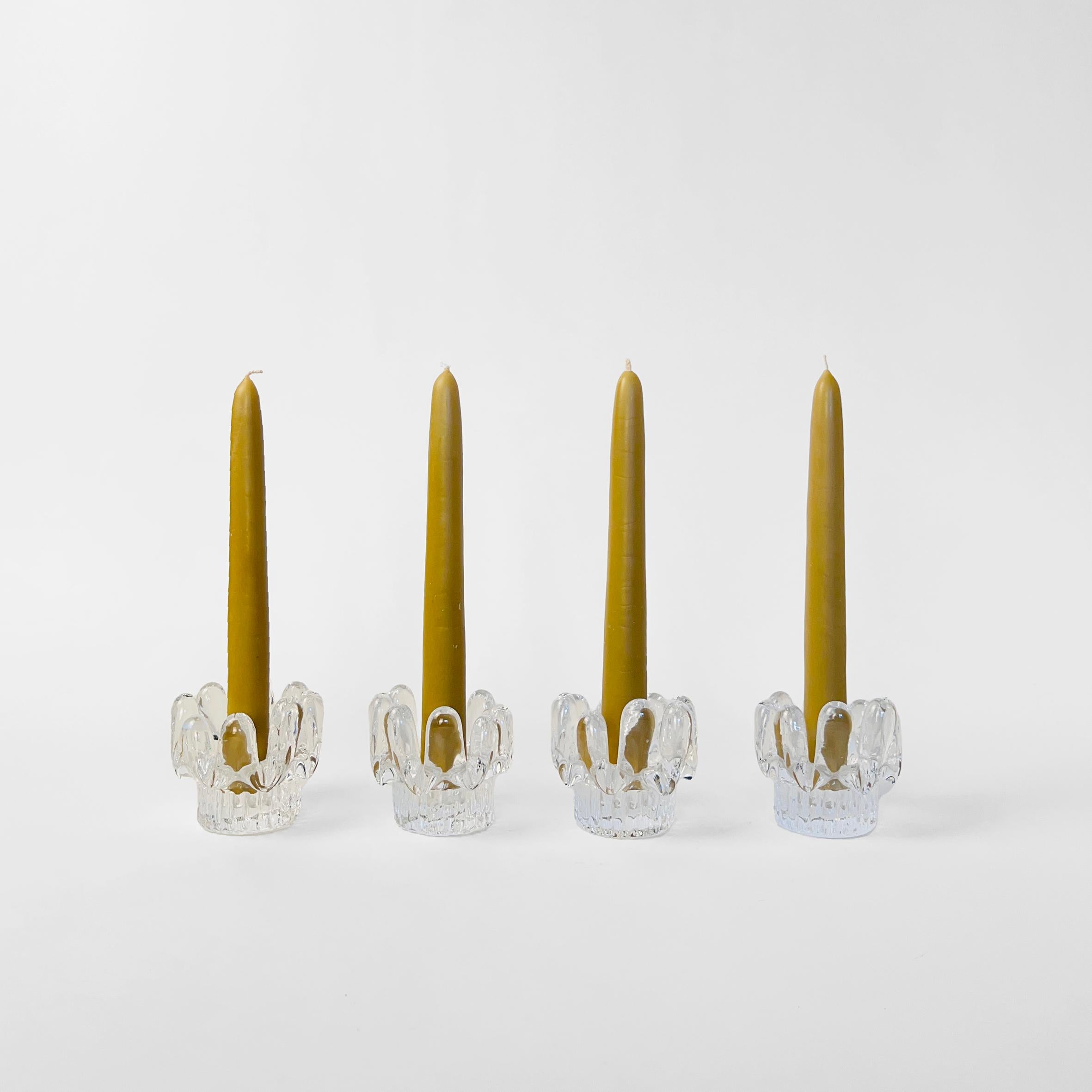 Set of four (4) sunflower candlesticks designed by glass artist Göran Wärff for Kosta Boda Glasbruk. Made in Sweden, 1970s.