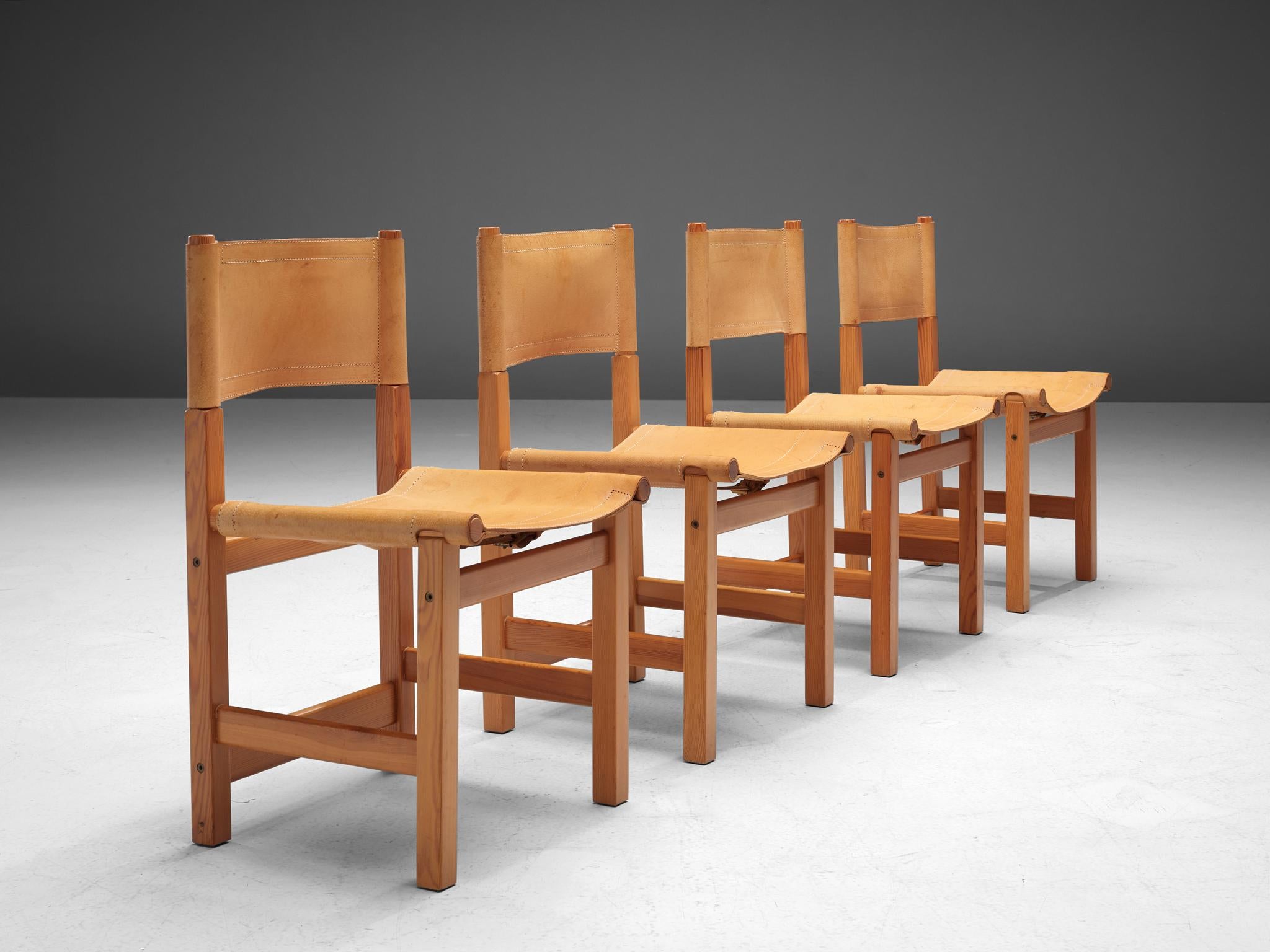 Set of four dining chairs, pine, cognac leather, Sweden, 1970s

A set of four beautiful and natural dining chairs produced in Sweden in the 1970s. The design of these chairs displays a robust appearance, yet these chairs have a soft and organic