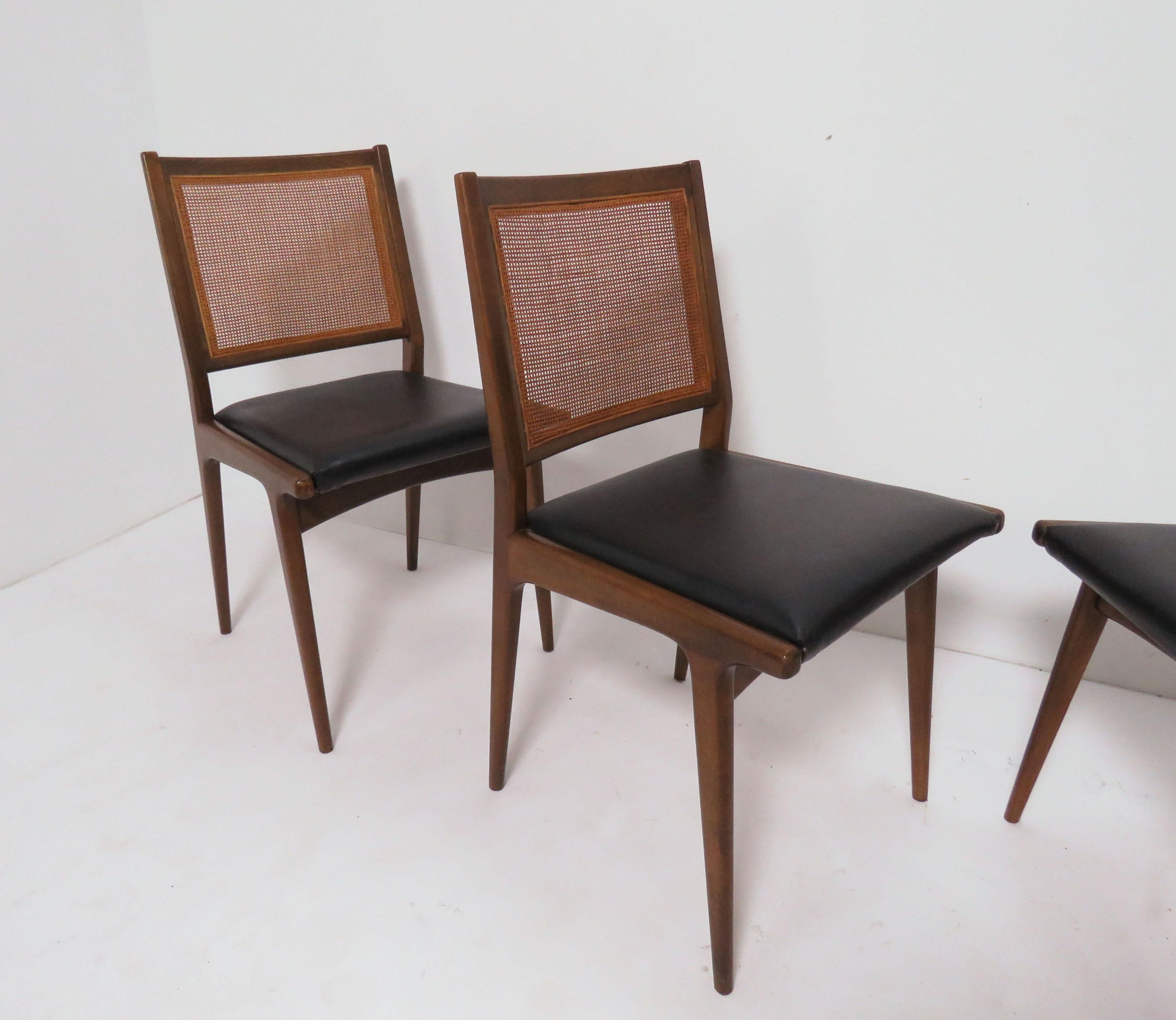 Set of four dining chairs, made in Sweden. With caned backs and sculptural lines, in the manner of Carlo de Carli, circa 1960s.