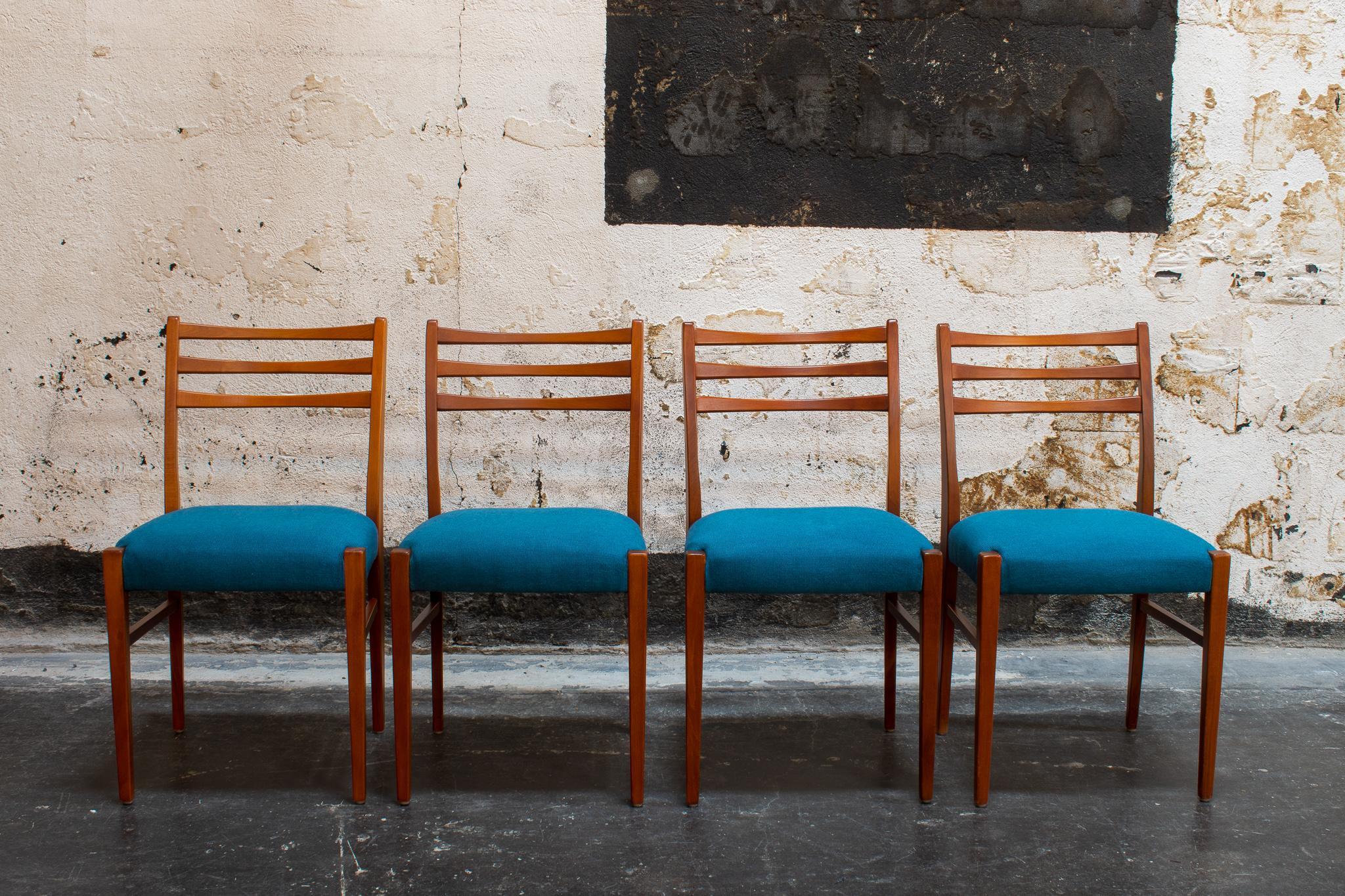 Set of four newly restored teak dining chairs from Sweden, c. 1960. Upholstered in blue ribbed fabric and ready for immediate delivery.