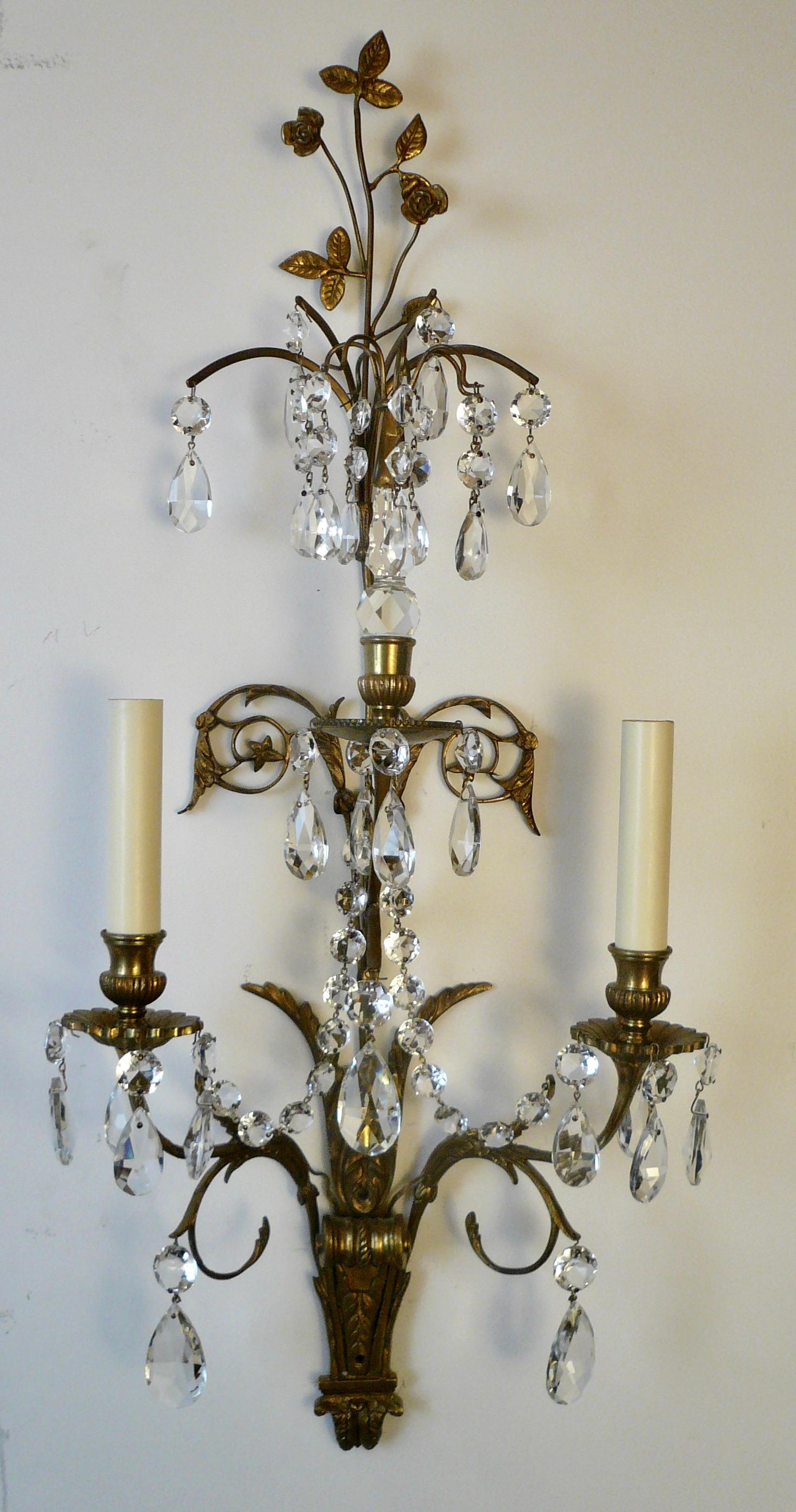 This handsome set of for sconces feature Classical motifs including acanthus leaves and almond shaped crystal drops.