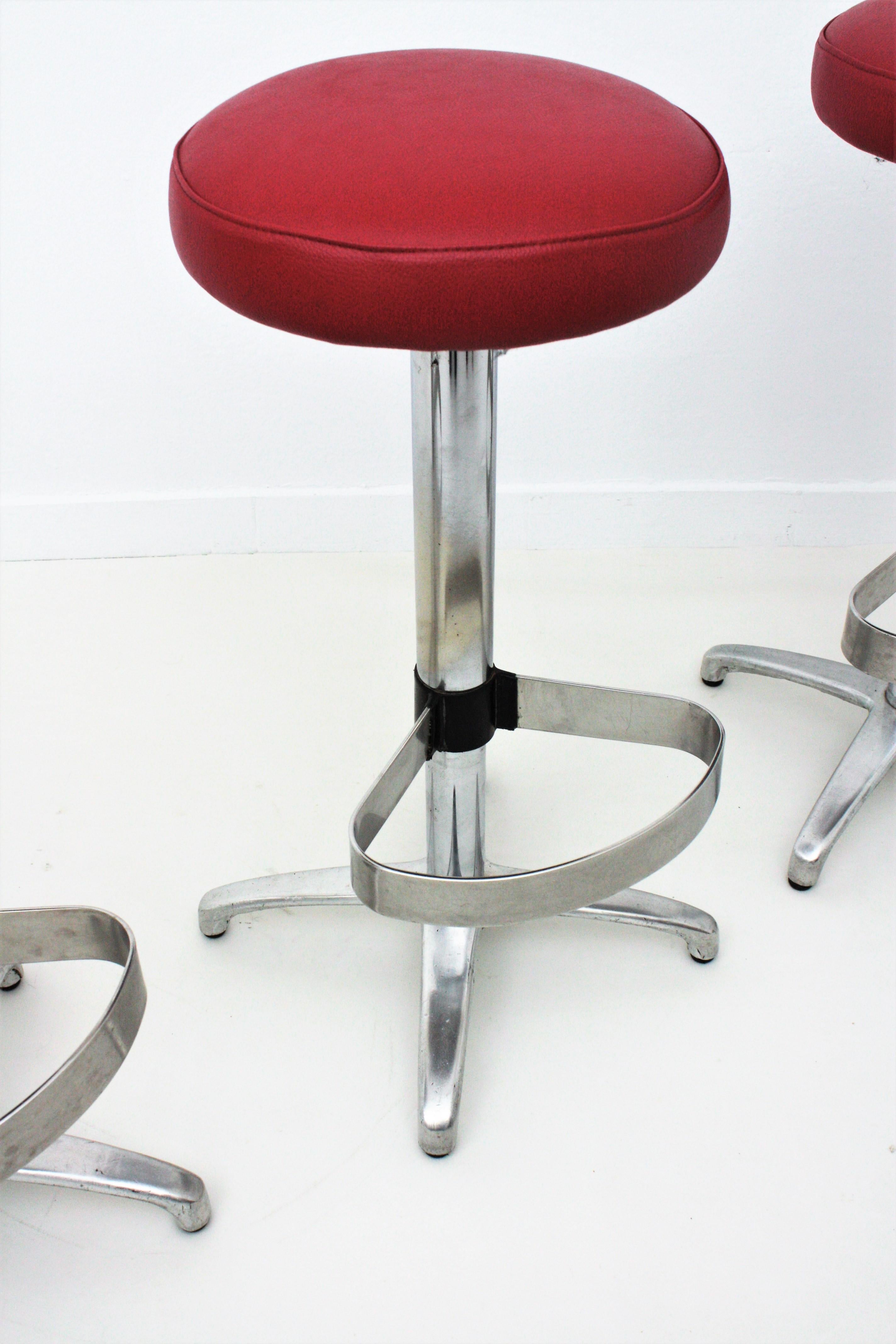 Steel Four Midcentury Bar Stools in Metal Upholstered in Red Leatherette For Sale