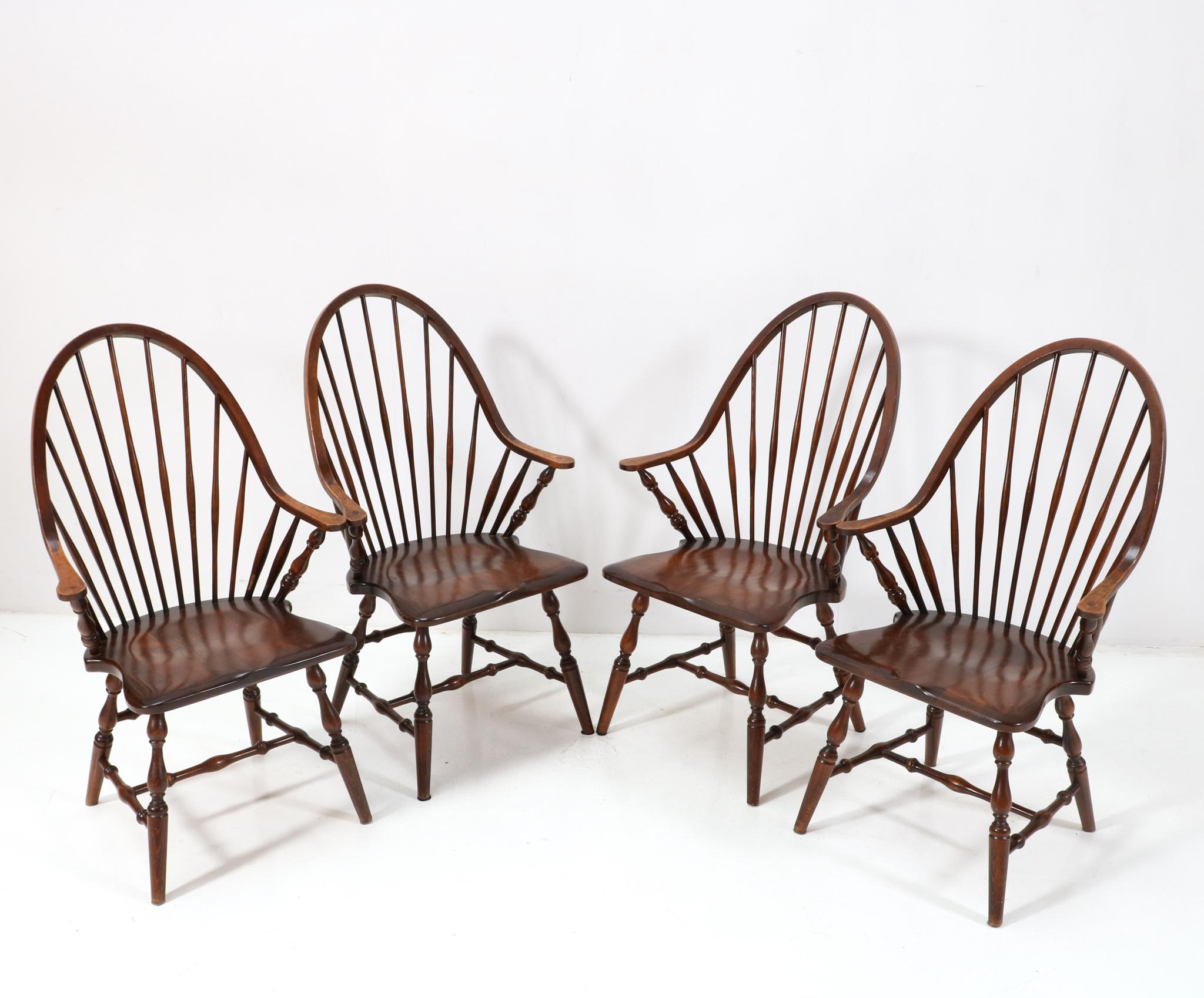 Amazing and rare set of four tall spindle back Windsor style armchairs.
Striking English design from the 1960s.
Solid stained beech frames with a warm maple/birch wood finish.
Quality construction and elegant design.
This wonderful set of four