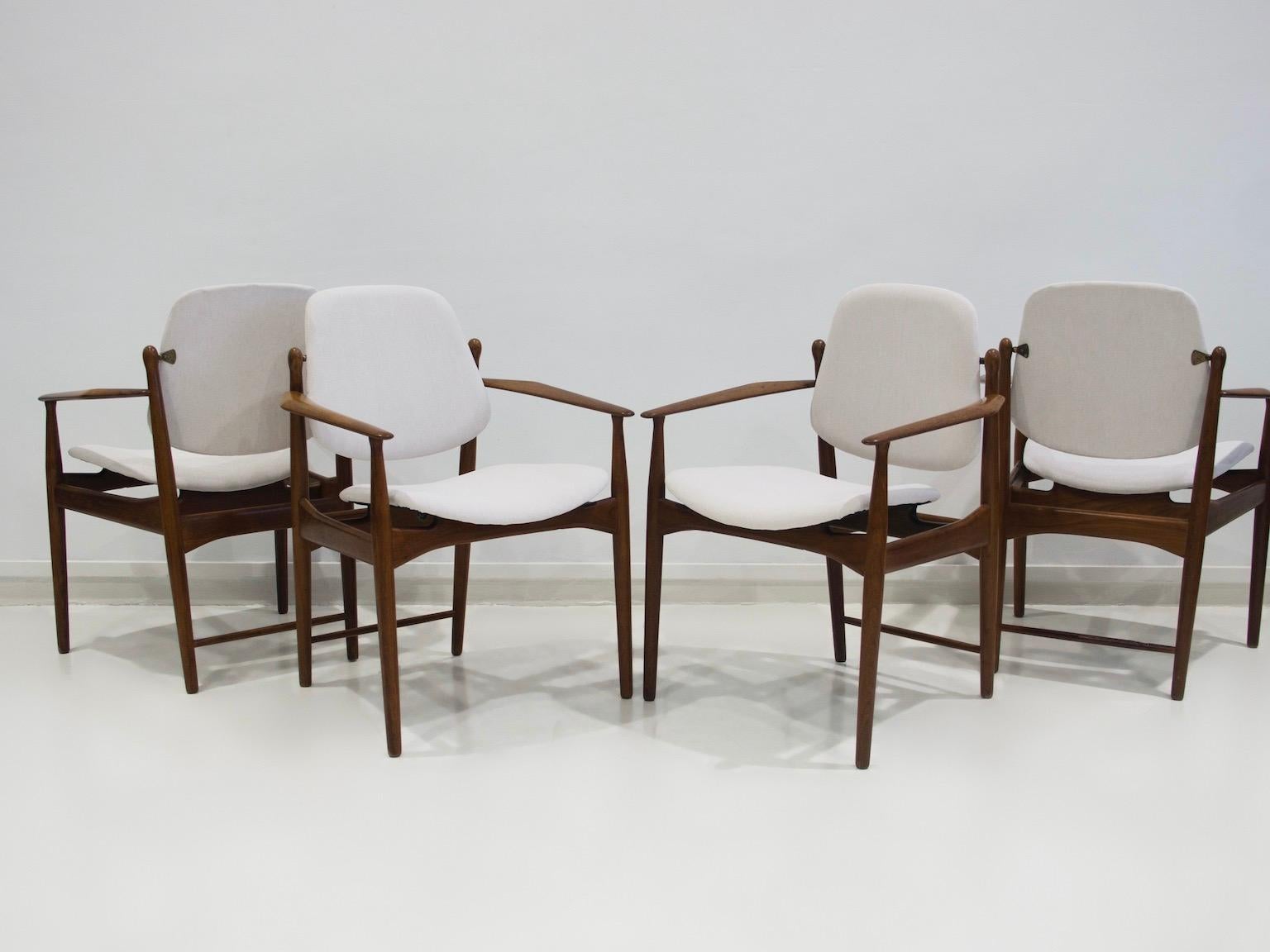 Four armchairs with teak frame designed by Arne Vodder and manufactured by France & Daverkosen in Denmark, circa 1950s-1960s. Upholstered seat and tilting backrest. Labeled France & Daverkosen, Denmark. New very light beige fabric upholstery, looks