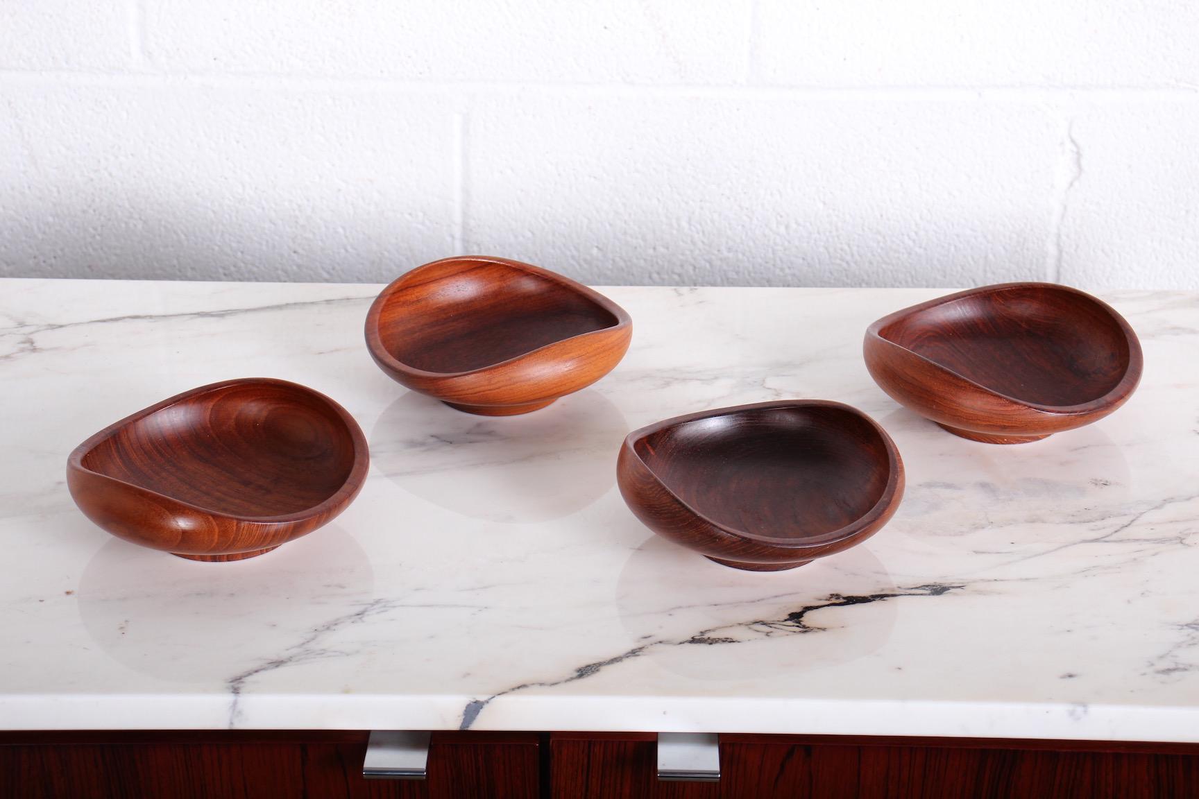 A set of four teak footed bowls designed by Finn Juhl for Kay Bojesen and produced in Denmark, circa 1950s. All signed with original patina.