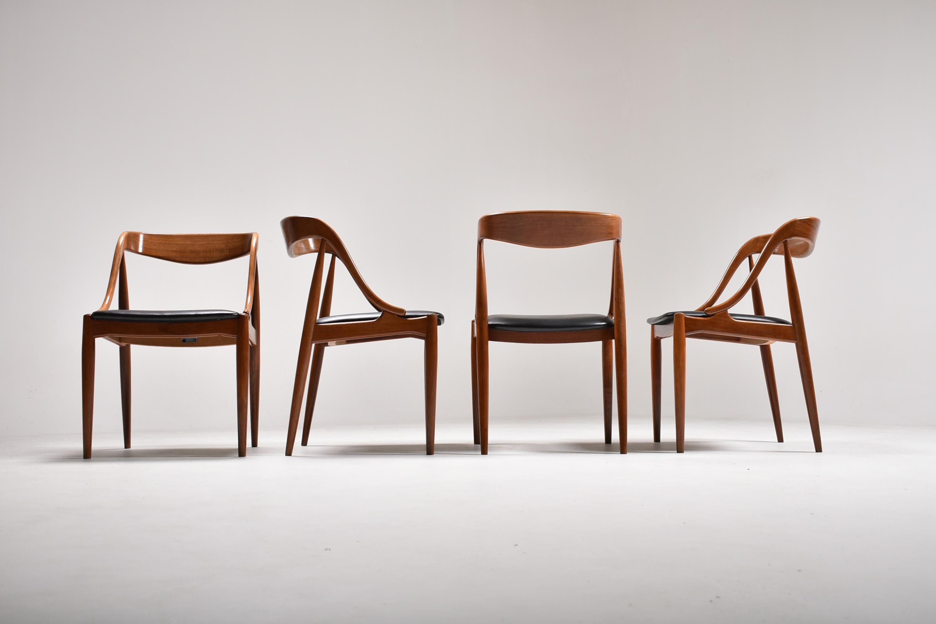A beautiful, sculptural set of Model 16 teak dining chairs designed by Johannes Andersen for Uldum Møbelfabrik, 1960s.
These elegant chairs have been re-upholstered in high quality black leatherette, and new fabric underside, for a perfect