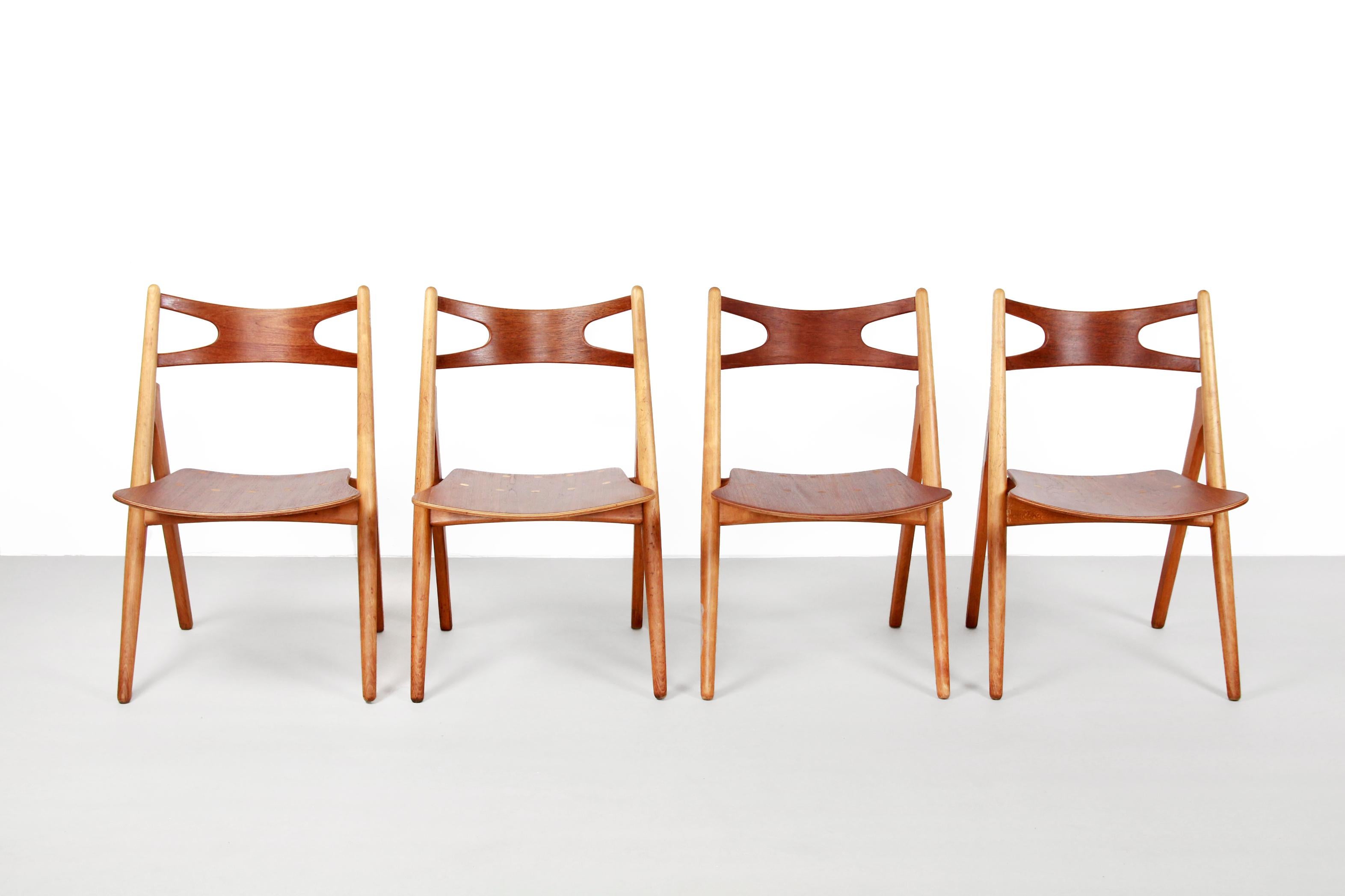 Very nice dining room chairs, designed by Hans Wegner and produced by Carl Hansen and Son in Odense, Denmark. It is a very old set in good condition. The frame of the chairs consists of solid beech wood and the seat and backrest of veneered teak.