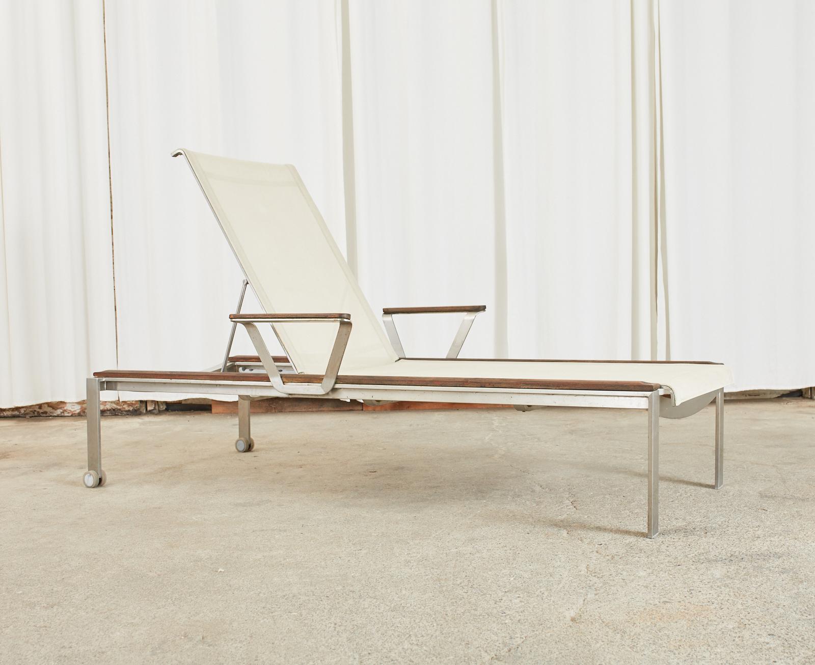 Gorgeous set of four modern poolside chaise longues produced by Kingsley Bate. Beautifully crafted from stainless steel frames with teak running boards on the top surfaces and armrests. The generous lounges have an adjustable back and large slings