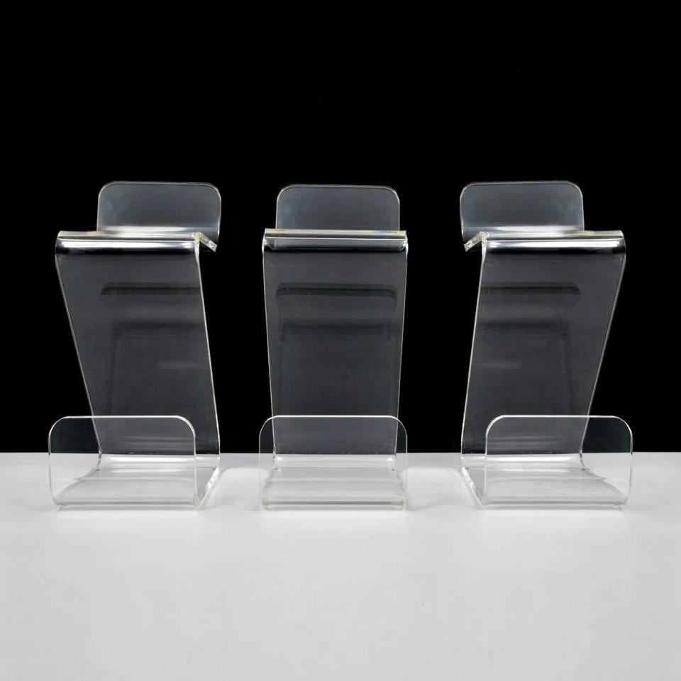 Set of four bar stools in thick Lucite by Gary Gutterman, circa 1970.