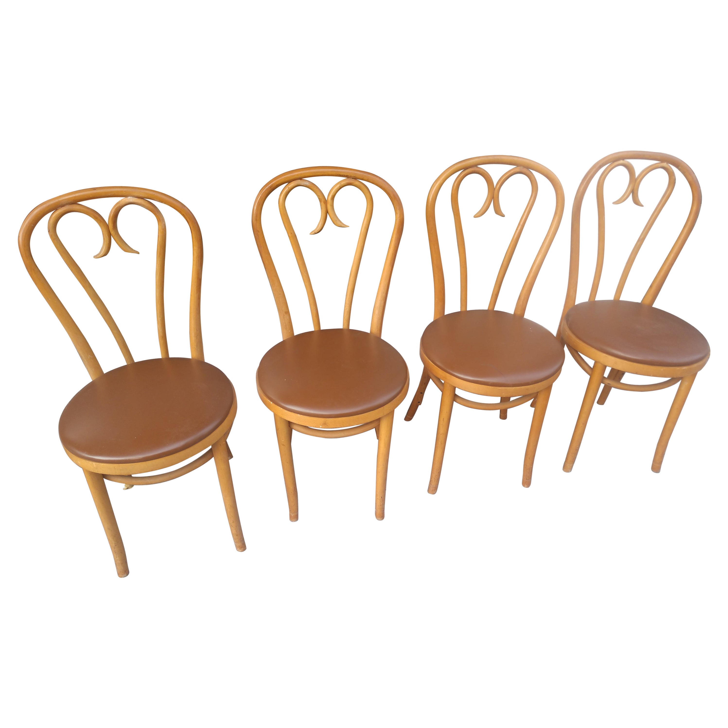 Set of 4 very sturdy and tight bentwood sweetheart chairs by Thonet and crafted in Romania. Brown vinyl seat seat covering that can be changed easily. C1960, from a Connecticut ice cream parlor.
Sold and priced as a set.