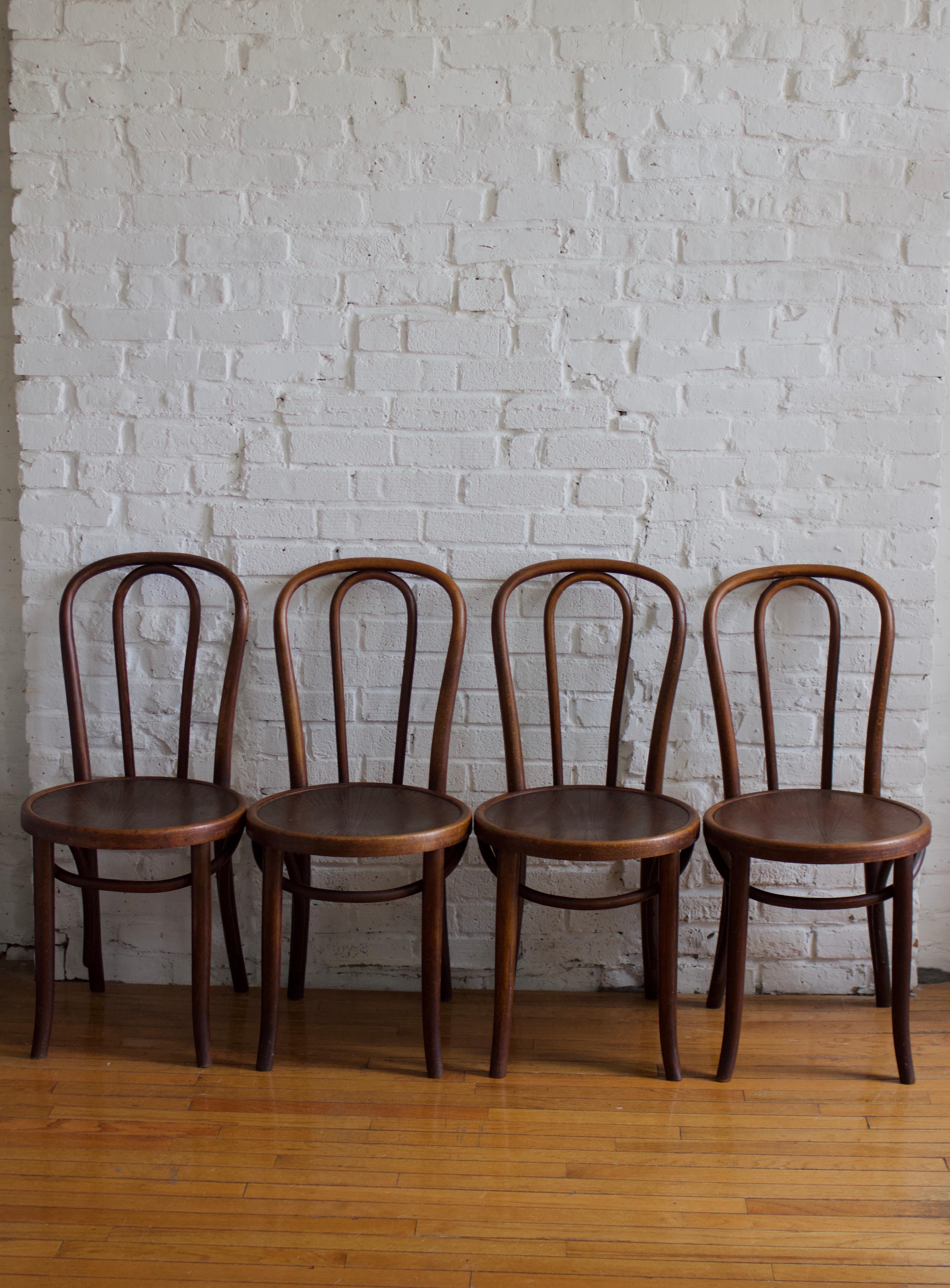 Set of four vintage No. 18 Bentwood chairs by Michael Thonet for ZPM Radomsko. Designed by Michael Thonet and produced by ZPM Rodomsko in Poland, which was a former Thonet factory until it was nationalized after WWII.

These chairs are made of