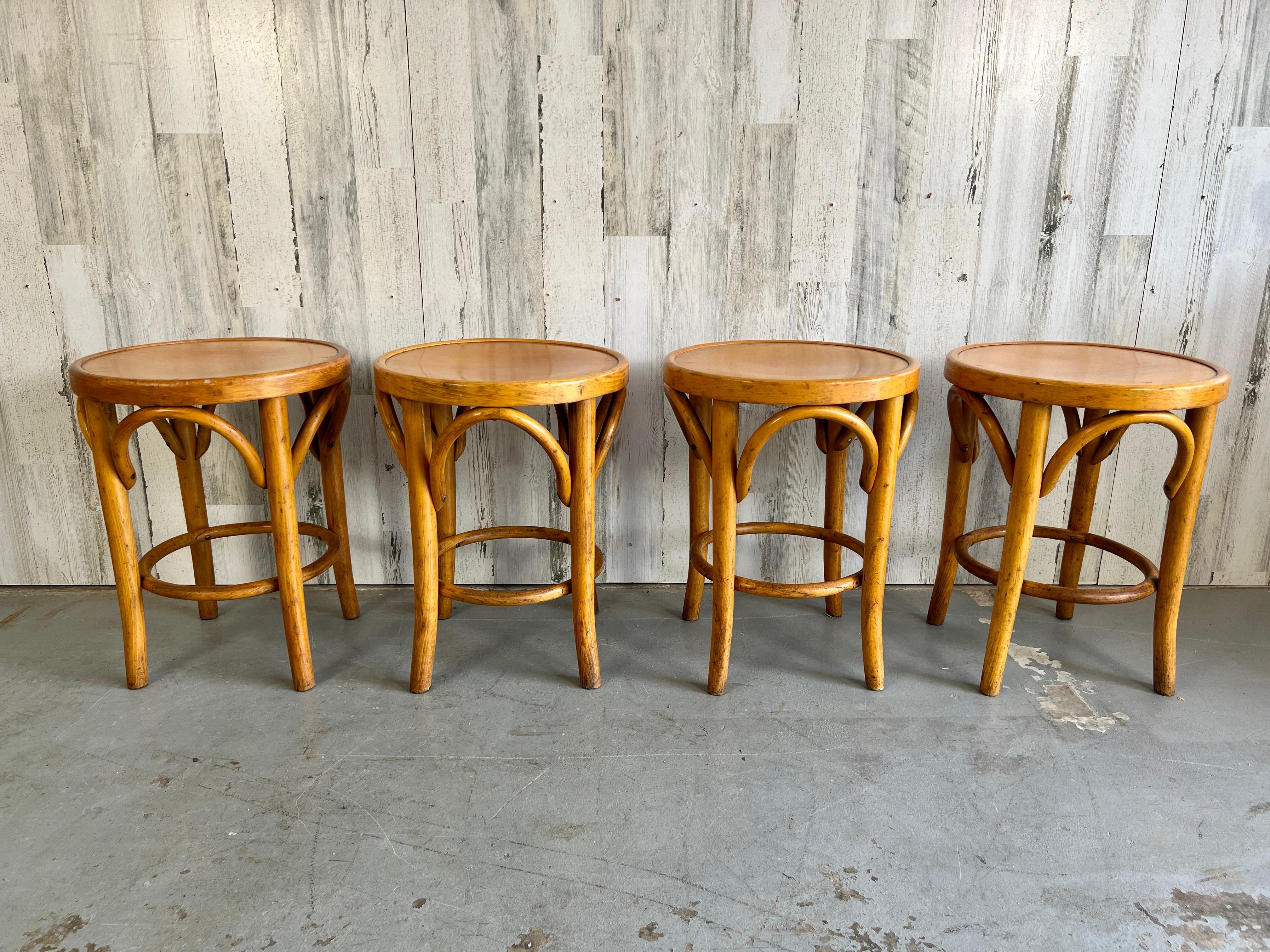 Hard to find a set of four Thonet bentwood stools in original finish, very sturdy with all the lines of classic Thonet.