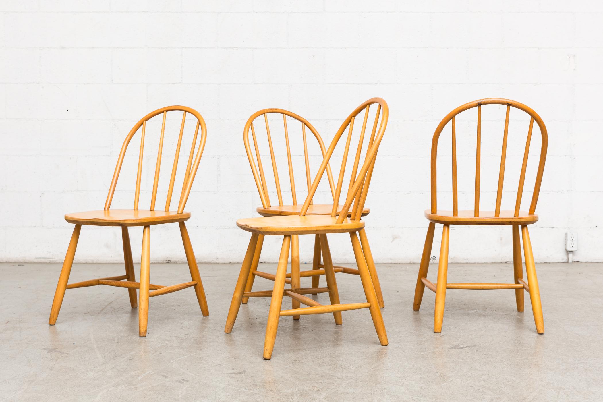 Set of 4 Tapiovaara inspired natural spindle back chairs. lightly refinished, slightly low seat height, Otherwise in good natural condition. Priced as a set. Other similar chairs available and listed separately