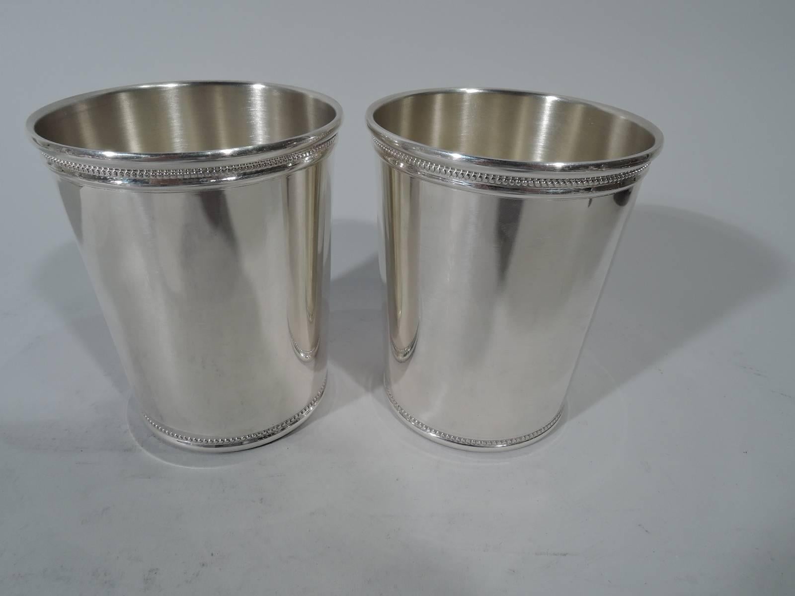 Set of four sterling silver mint julep cups. Retailed by Tiffany & Co. in New York. Straight and tapering sides and beaded rims. Hallmarked. Total weight: 19 troy ounces.