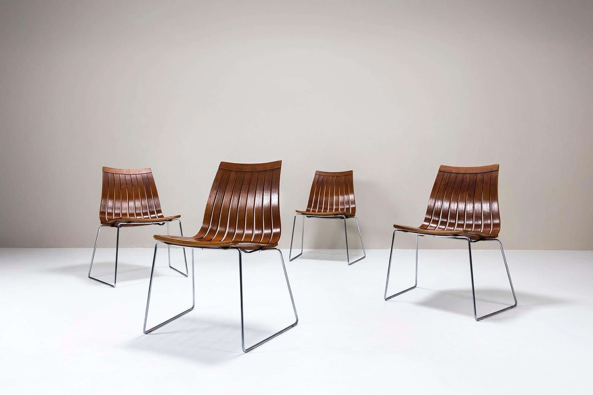 A striking and rare set of four Tønnestav dining chairs by Kjell Richardsen, designed in 1960 and manufactured by Tynes Møbelfabrikk in Norway. These chairs had a brief yet notable production run due to a legal dispute with designer Hans Brattrud. A