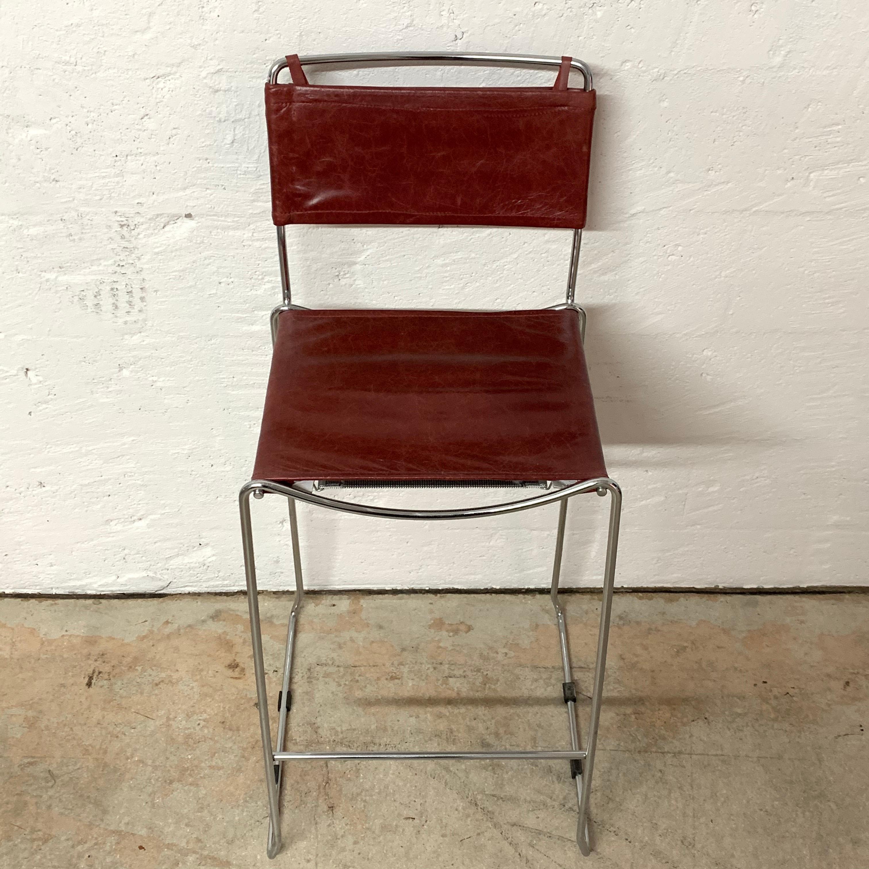 Four stackable bar stools rendered in chrome-plated steel and ox blood red leather seat and back designed by Toyoda Hiroyuki for ICF Group.