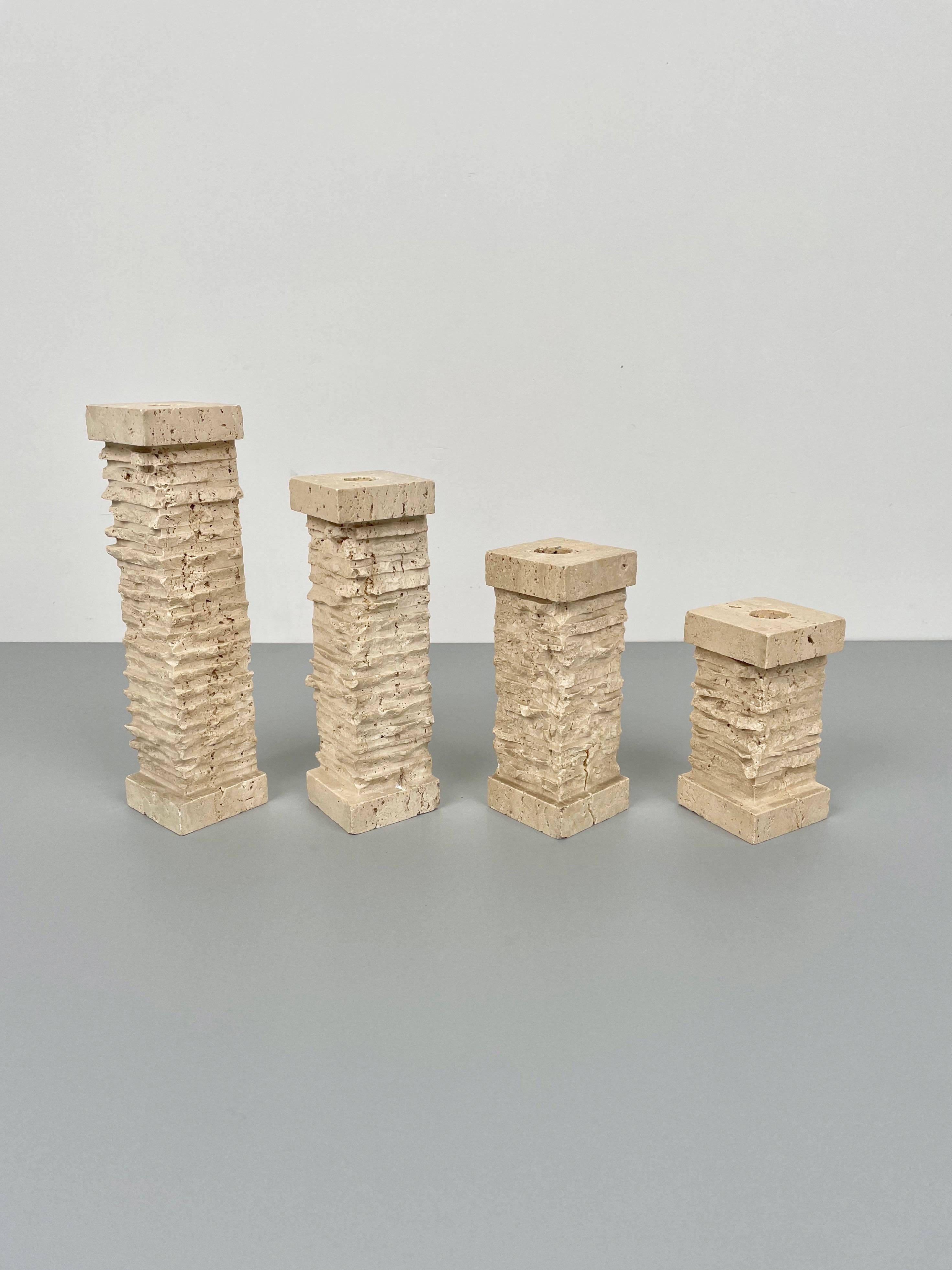 Set of four candle holders in travertine marble in the shape of ancient walls made in Italy in the 1970s.

The four pieces lay on squared bases of 6 x 6 cm but come in decreasing heights, in order: 24 cm, 20, cm, 16 cm, 12 cm.