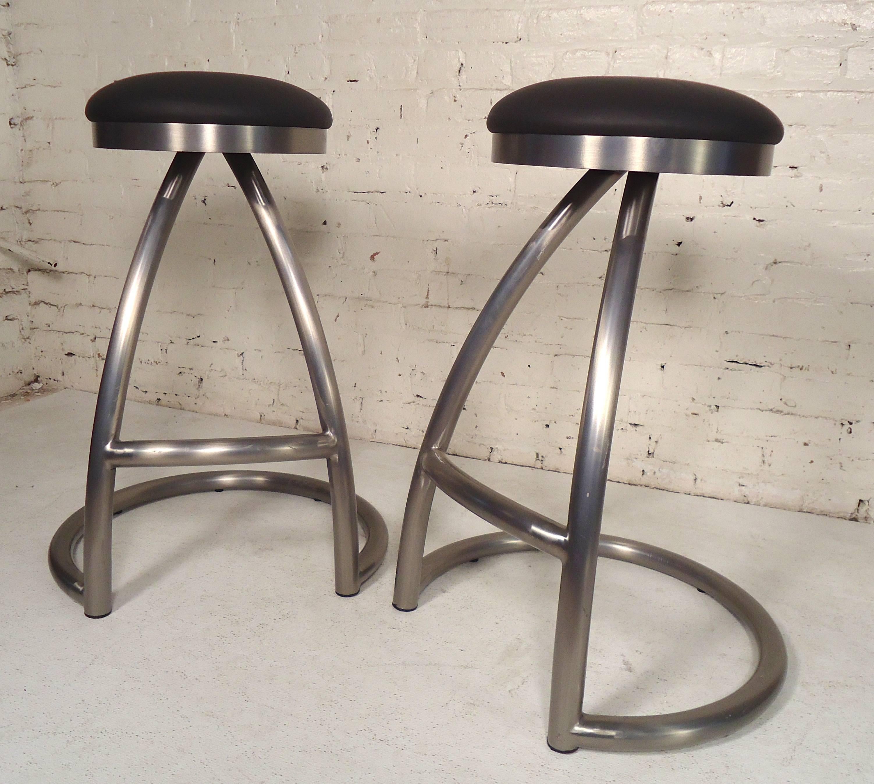 Four heavy stools with black cushioned seats. Thick metal frames with footrests.

(Please confirm item location - NY or NJ - with dealer).
 