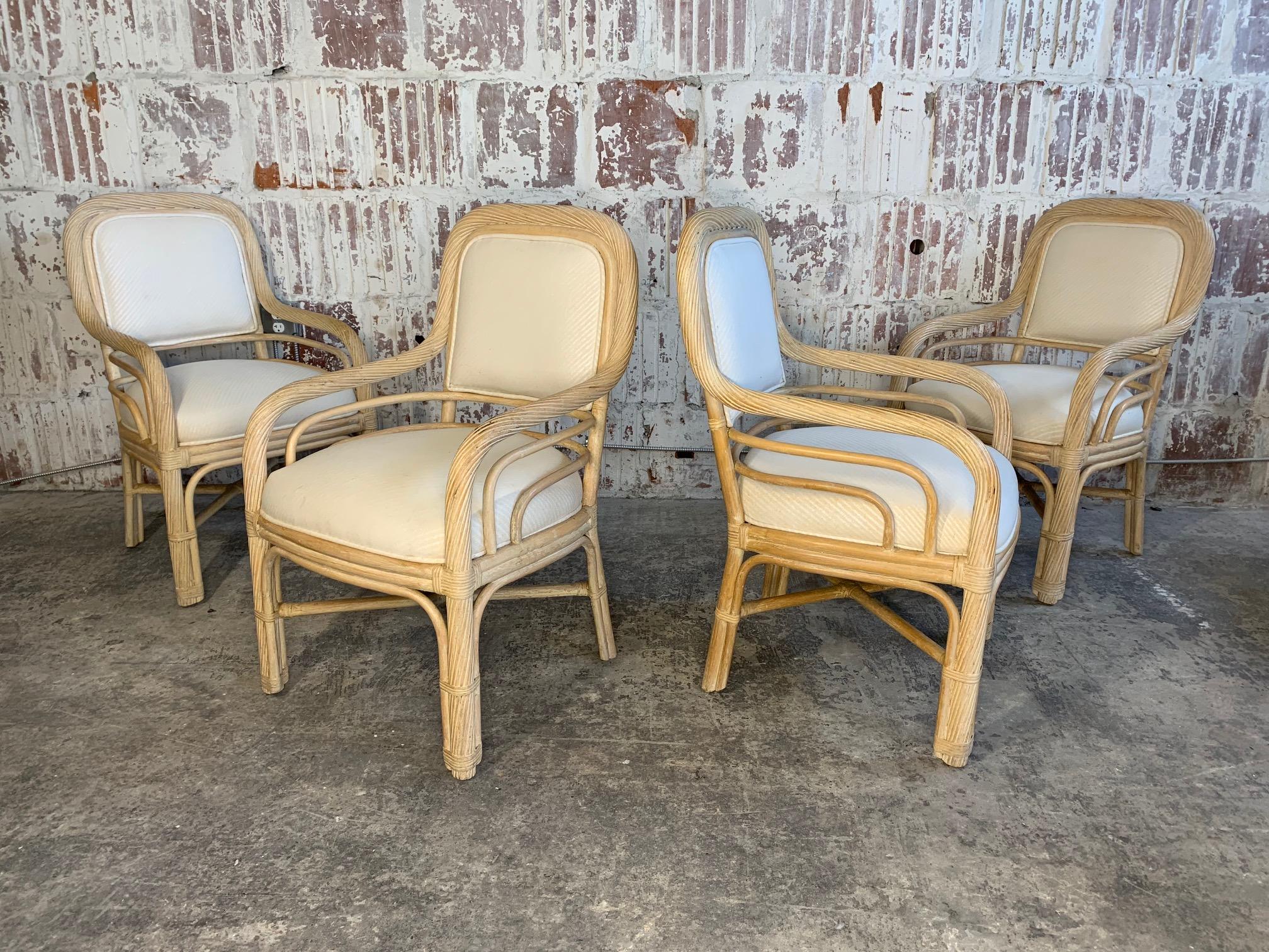 Set of 4 twisted rattan dining chairs feature tone on tone striped upholstery and are in very good vintage condition with minimal signs of age appropriate wear.
Measures: Arm height is 24