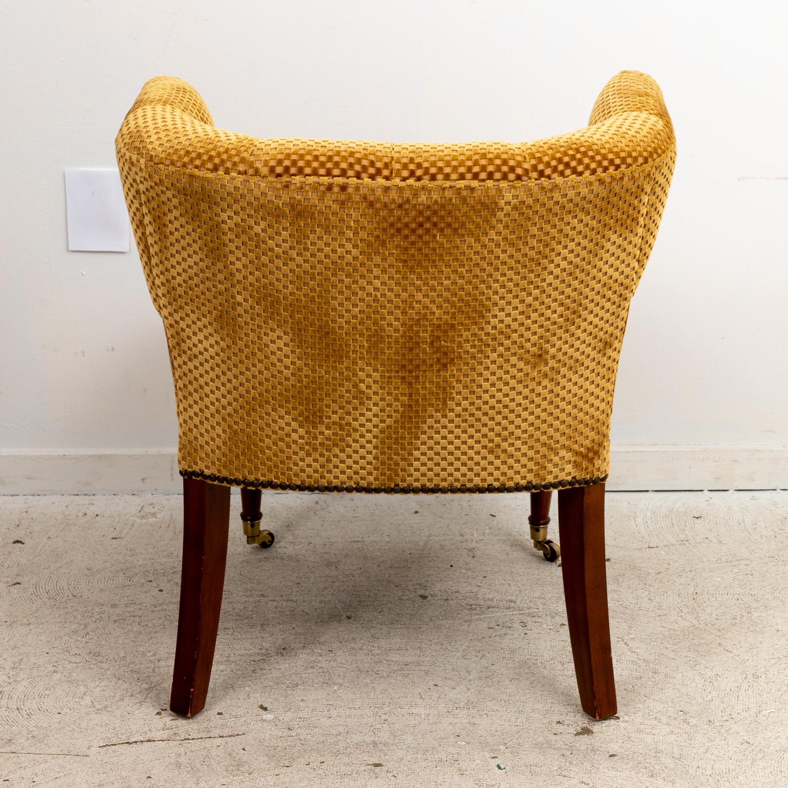 Set of six upholstered card table chairs with curved seat back and tufted upholstery. The chair is also constructed with metal nail head trim and ball turned front legs on castors.