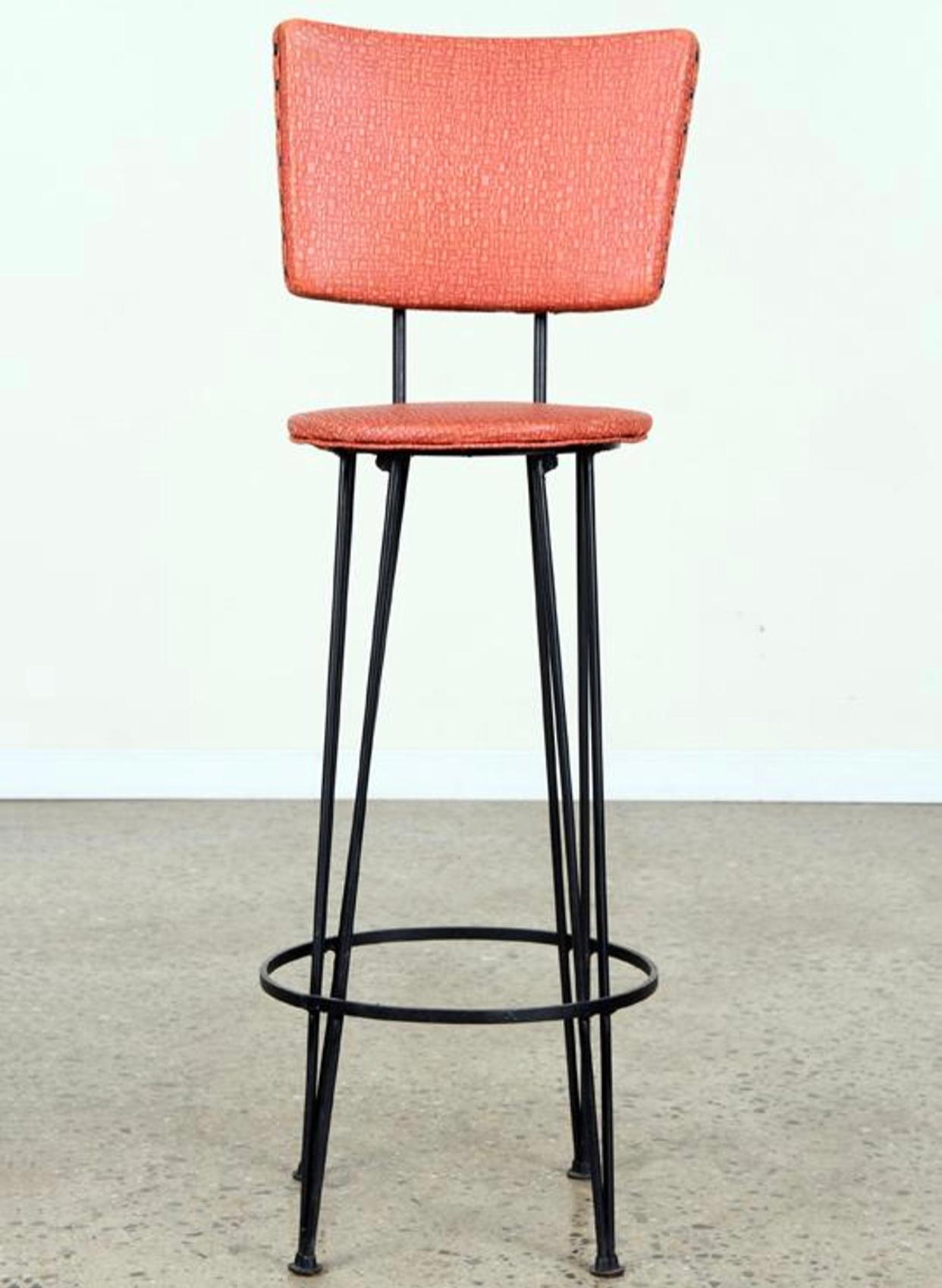 A set of four upholstered iron bistro stools having hairpin legs. Height 42.75