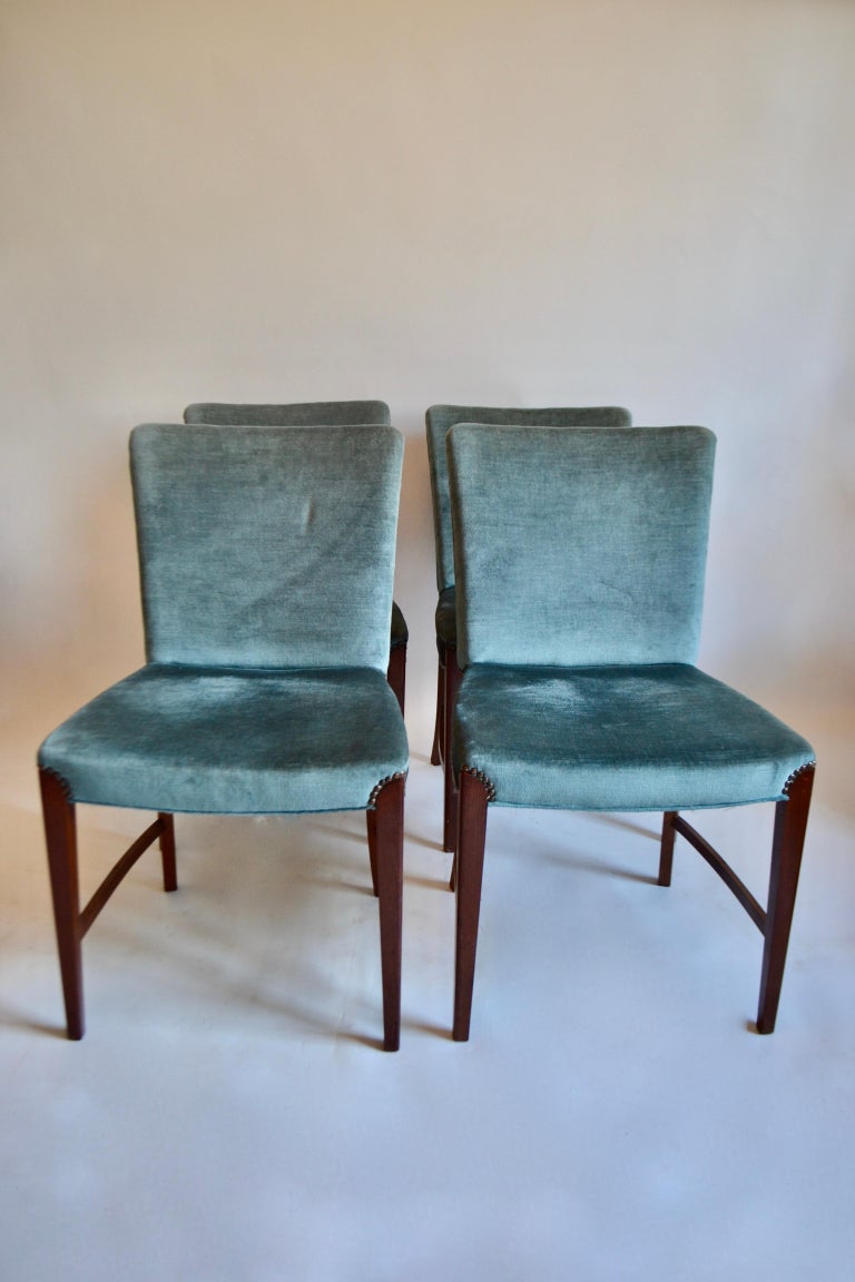 Set of 4 Danish dining chairs by P. A. Nielsen & Co Copenhagen from the 1940s. Walnut dining chairs with original blue velvet upholstery throughout. Cushioned seat and backrest raised on shaped supports.

 