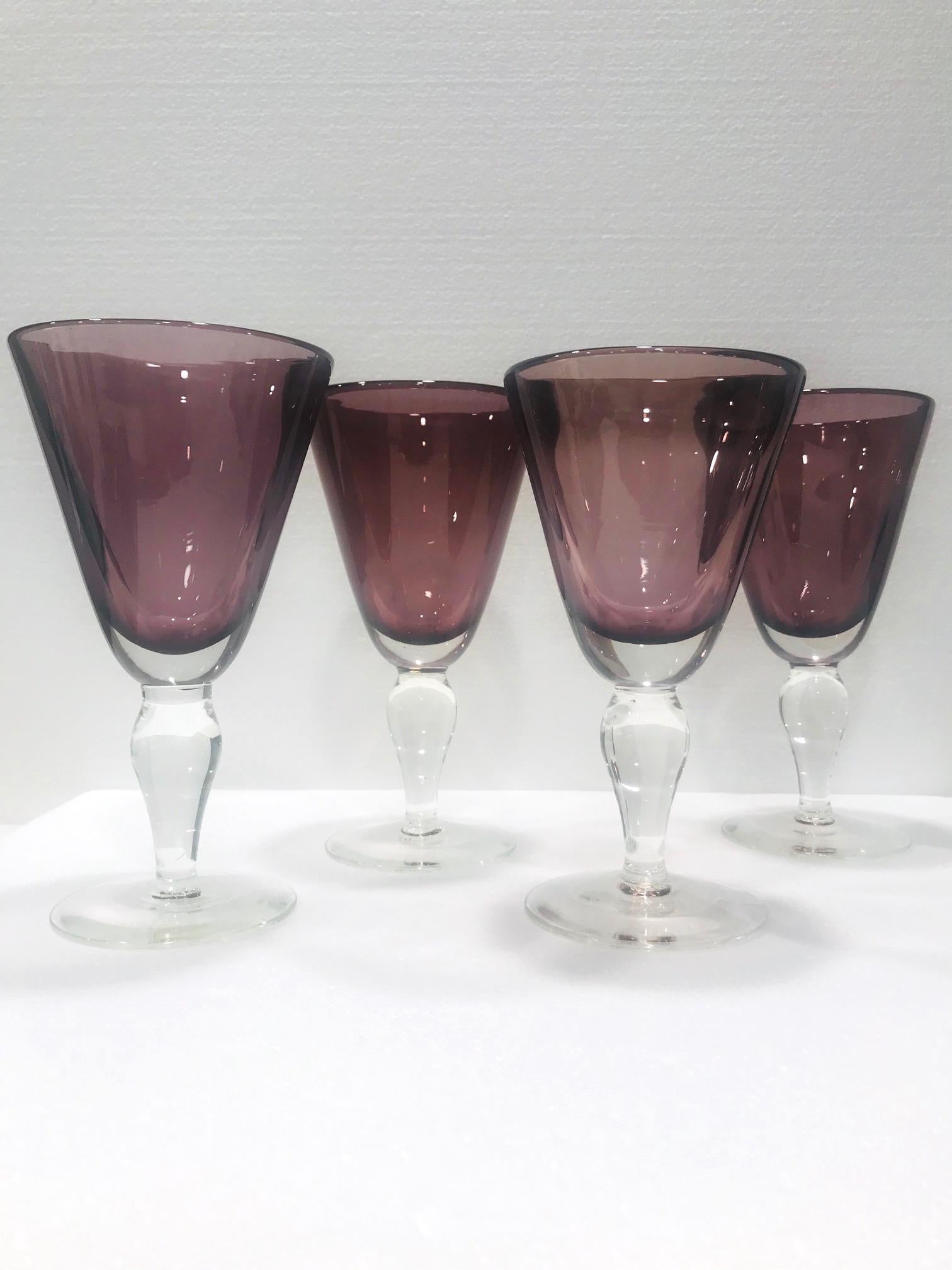 Set of four vintage wine glasses or water goblets in handcrafted Murano glass. Venetian glasses made with blown Sommerso technique featuring gorgeous purple amethyst glass floating within clear glass. Stylized stems with bulbous forms and polished