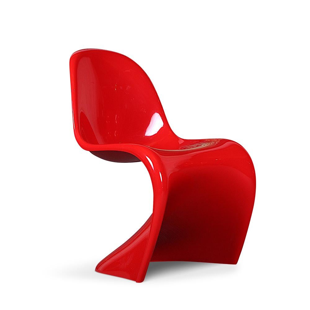 Set of four Verner Panton designed cantilevered bright red chairs produced by Vitra. Sturdy and comfortable and in excellent original condition with an un-faded and clean finish. The Panton chair is an important icon of modern design and has a