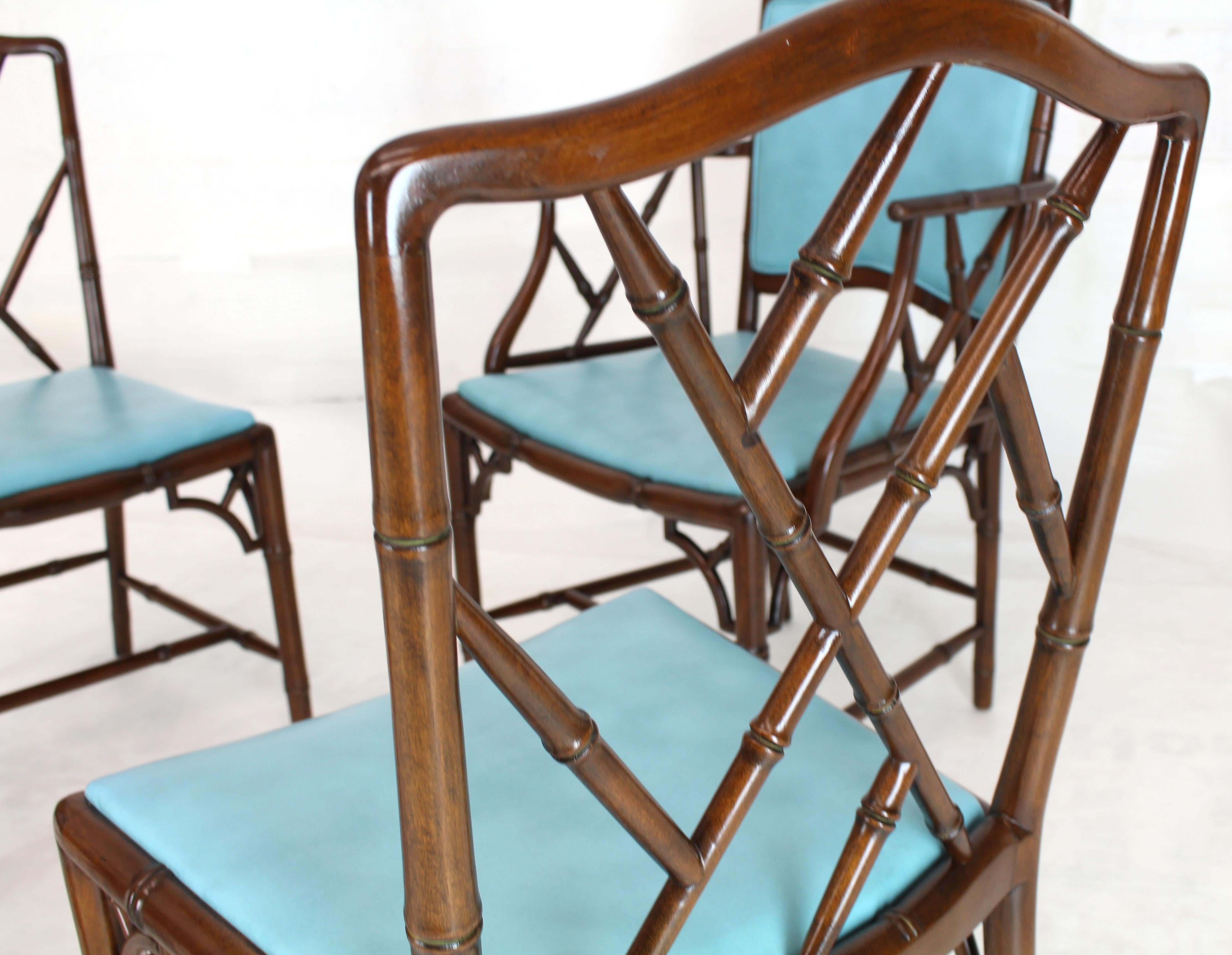 Set of four Mid-Century Modern faux bamboo mahogany dining chairs. Turquoise upholstery in excellent original condition. The posted dimension is for the side char. The armchair measures: 25 W, 22 D, 37 H. The width is from arm to arm.
 