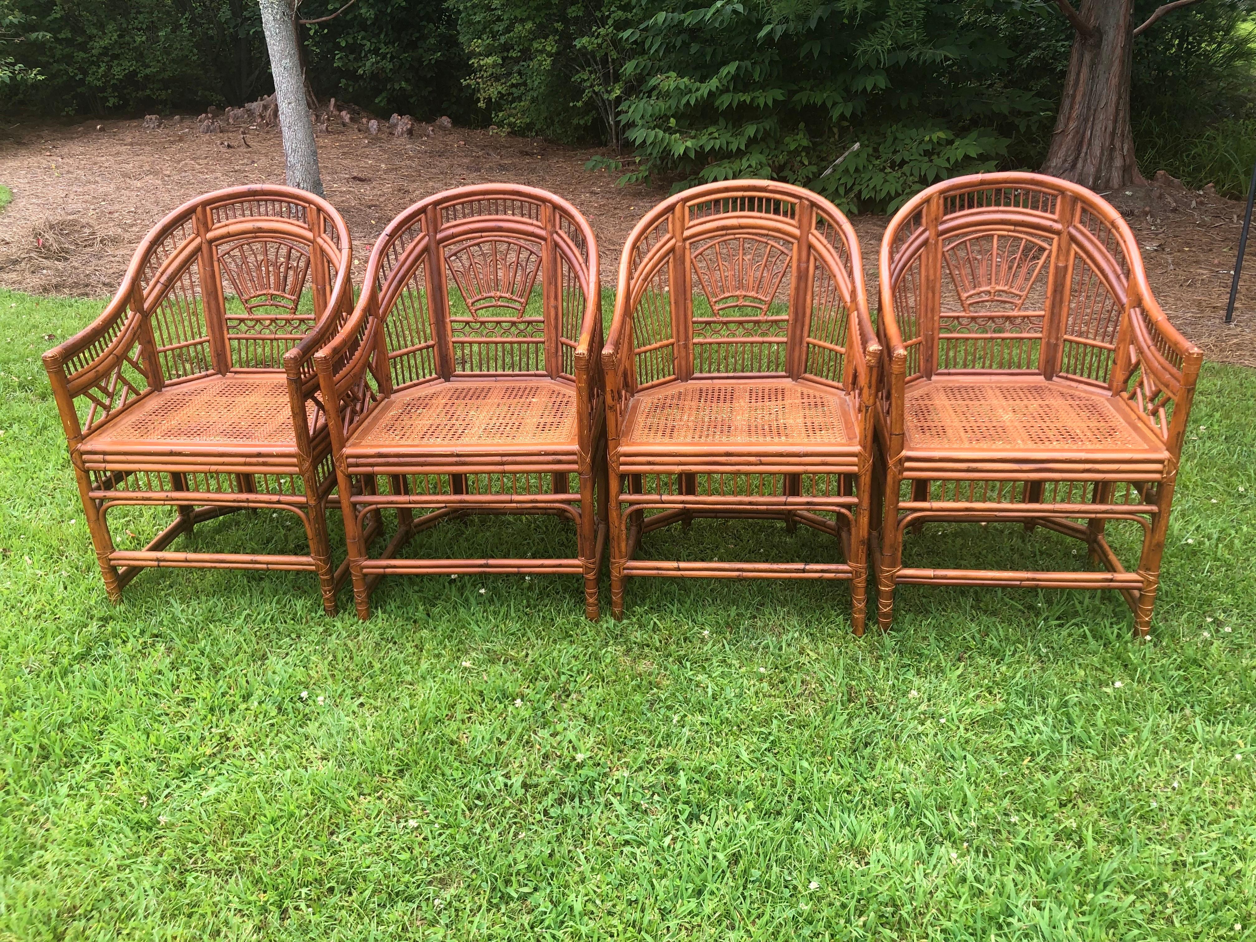 Set of Four Vintage Brighton Pavilion Style Chinese Chippendale Rattan and Split Reed Chairs with Caned Seats. Brighton Pavilion refers to the Royal Pavilion in Brighton, England. It is a famous and distinctive building with architectural and design