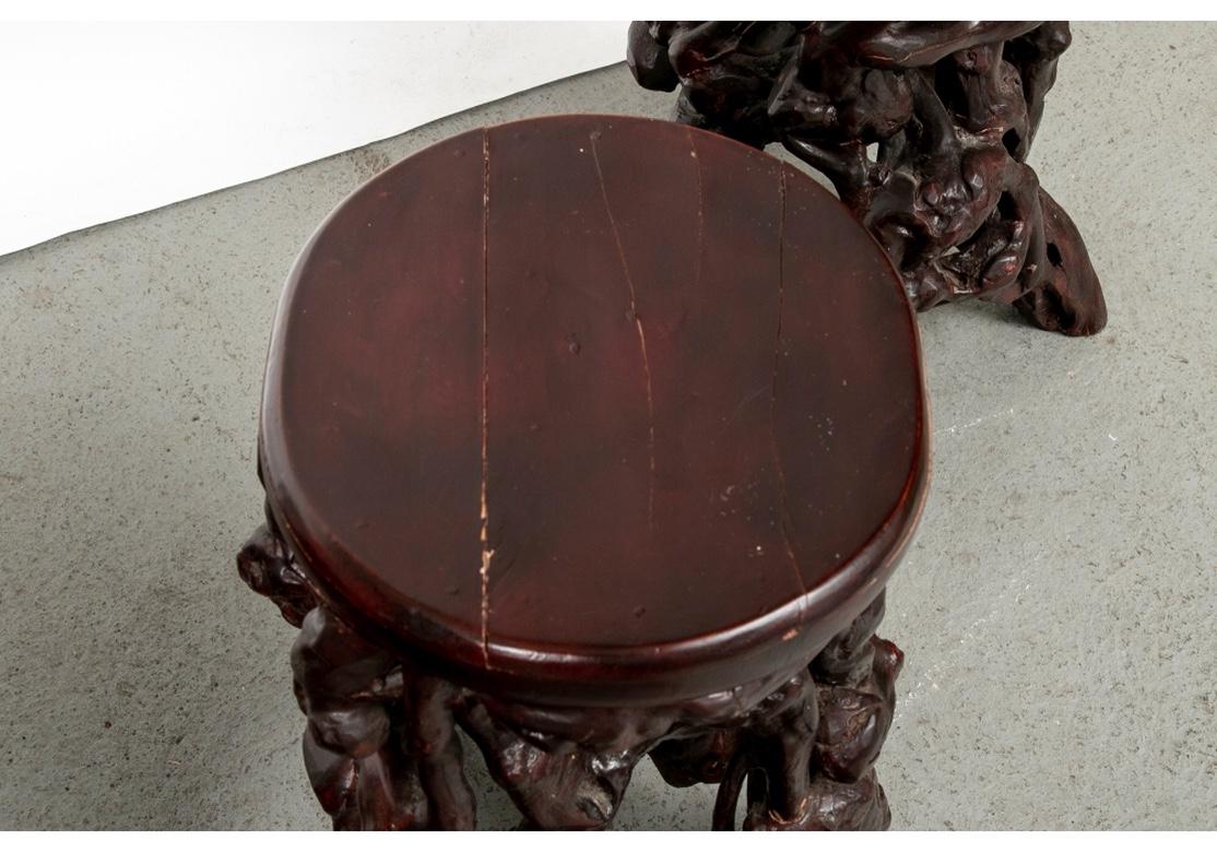 A solid set of four vintage Asian root stools. All with dense interlaced roots with splayed ends and oval tops. In a dark reddish brown stain. 
Measures: H. 19 1/2