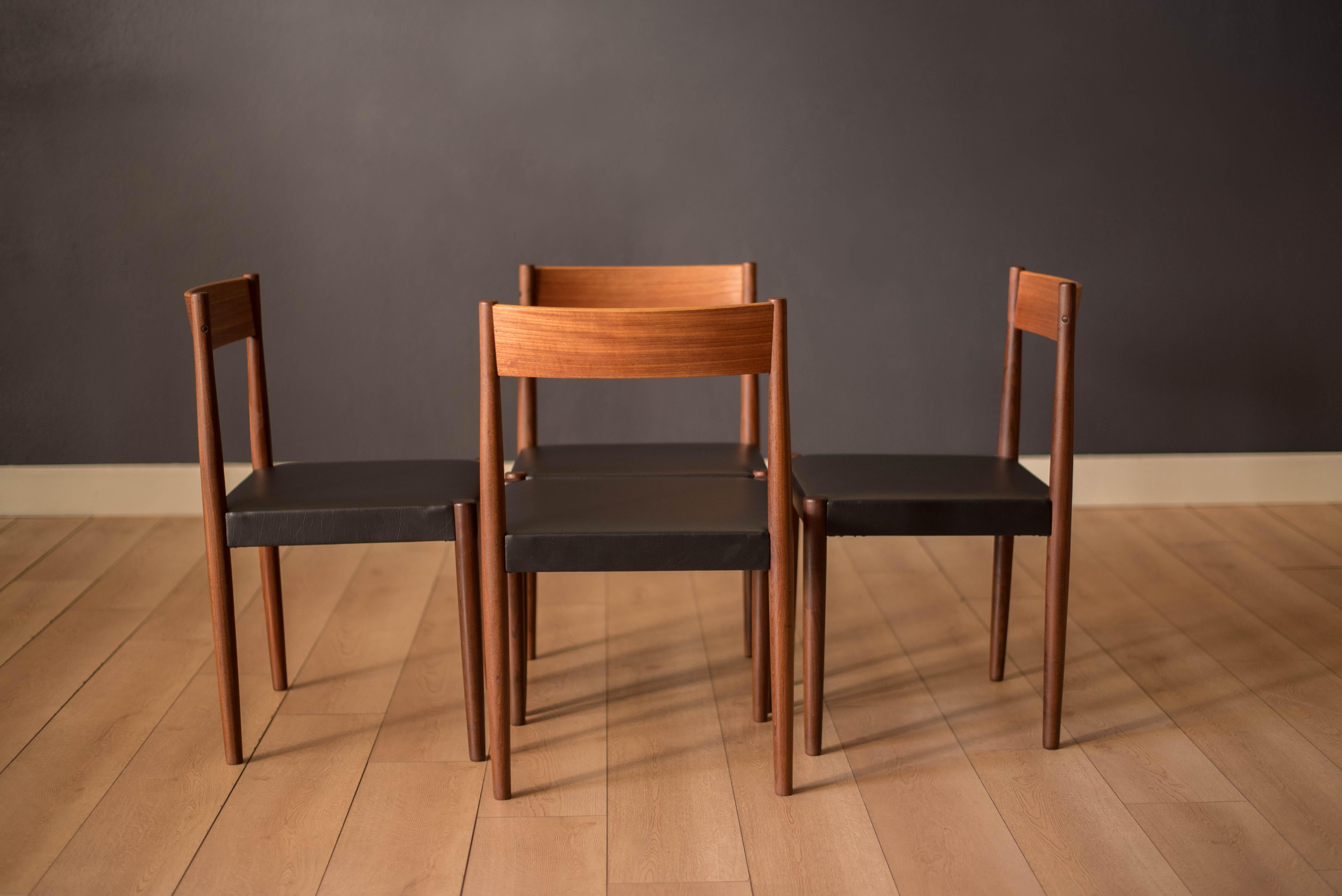 Mid century modern dining chairs designed by Poul Volther for Frem Rojle, Denmark circa 1960's. Features a curved backrest support and pencil tapered legs in old growth teak. This set includes four side chairs that have been newly reupholstered in