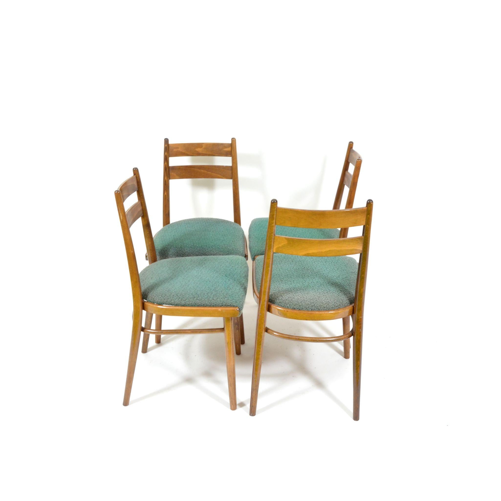 Set of four dining chairs made of beechwood. Wood in very good original condition. Green upholstered seat also in original, condition. Chairs are stabile. Made in Czechoslovakia during 1970s. Second set of four chairs available.